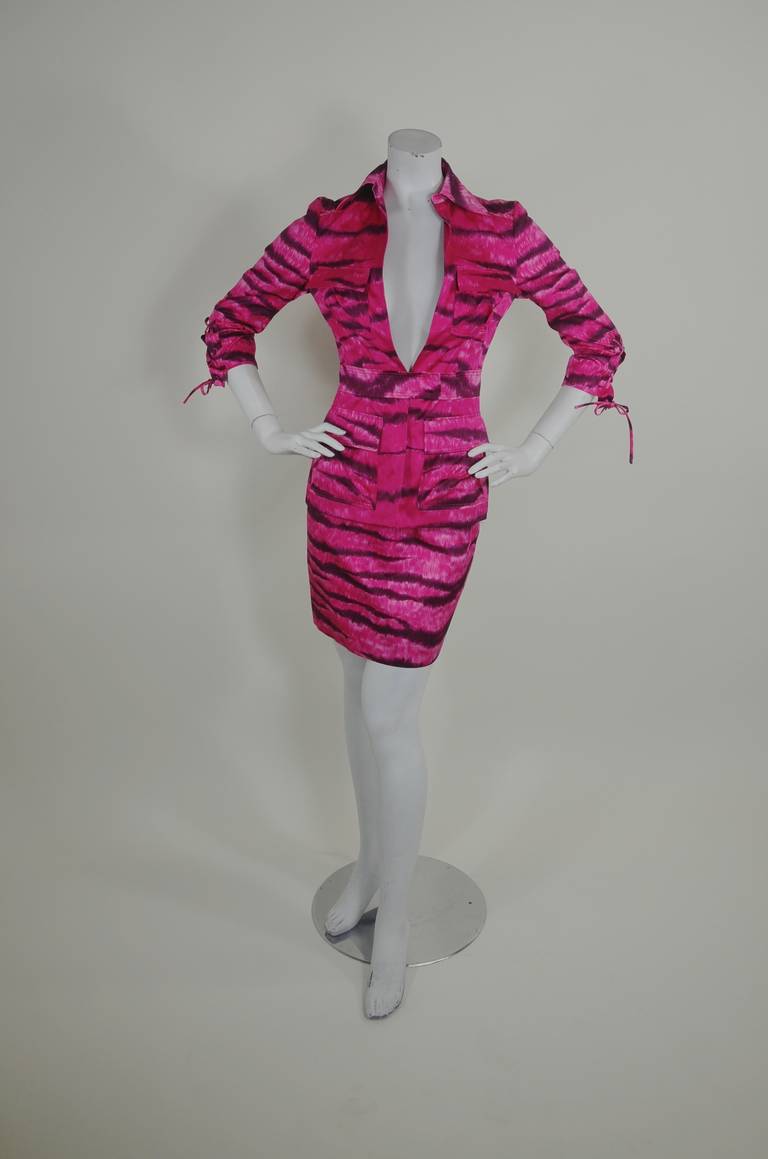 All aboard the fashion safari! This fabulous shocking pink zebra suit from Moschino features a safari jacket silhouette with multiple pockets, lace-up sleeves, and of course a plunging neckline. 

-Safari silhouette
-Lace-up detail
-Cargo
