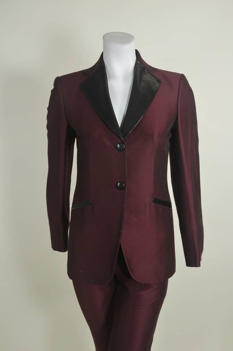 A luxe, beautifully tailored tuxedo from Moschino, featuring metallic burgundy and black lurex trim. Jacket features two pockets and a slim fit. Wool. Side zipper trousers. Jacket measurements below, trouser measurements as follows: 
Waist: 25
