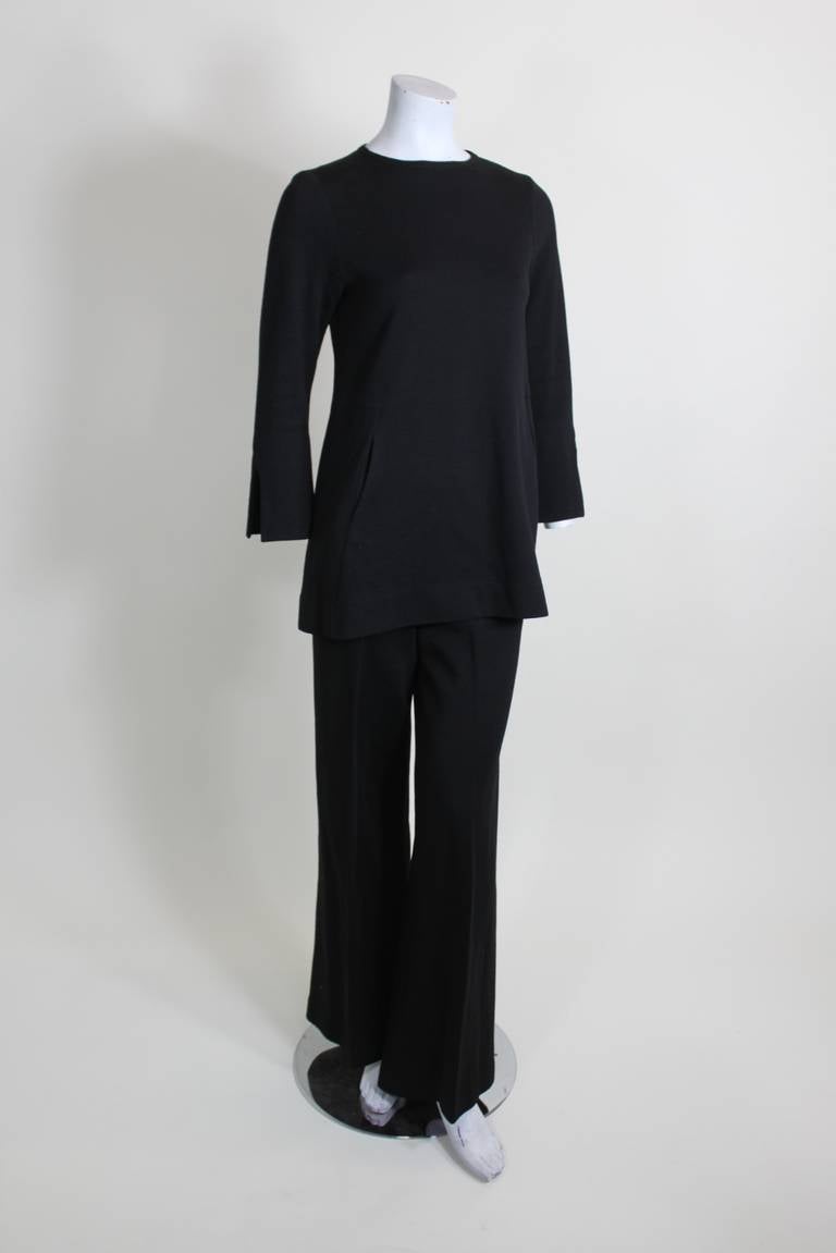 A gorgeous wool ensemble from iconic 1960s designer Rudi Gernreich. The tunic top features three-quarter length sleeves with a side slit, and pockets on either side. The trousers have a flared leg and beautiful center pleat.