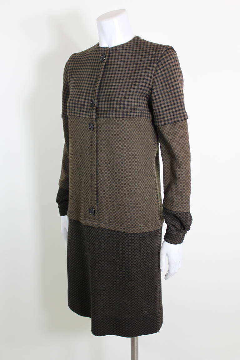 A knit dress from Rudi Gernreich featuring three sections of mocha check patterns. The shoulders have strong seams that give the illusion of a vest.