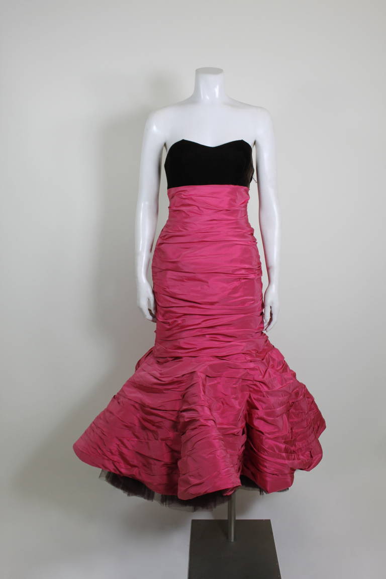 A gorgeous raspberry taffeta ruched strapless gown from Christian Lacroix. The bust feature rich chocolate brown velvet, and the mermaid skirt has layers of tulle for added volume and structure. Gown has boning and