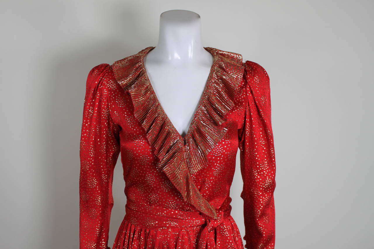 1970s YSL Red and Gold Lamé Ruffled Ensemble

Measurements--
Blouse Bust: 34 inches
Blouse Waist: 28 inches
Blouse Length: 24.5 inches

Skirt Waist: 26 inches
Skirt Hip: up to 40 inches
Skirt Length, Waist to Hem: 26 inches

Belt Length: