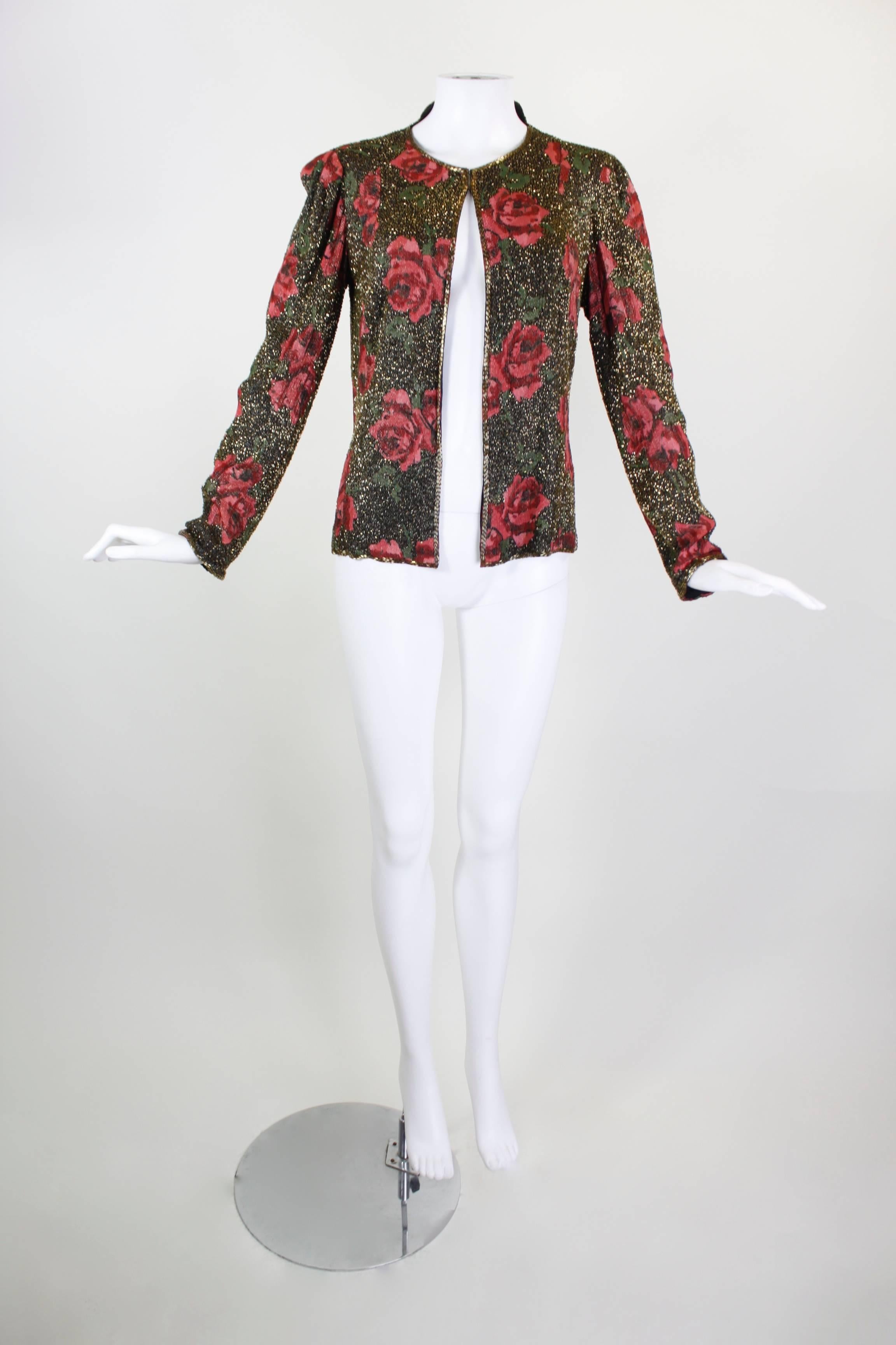 This gorgeous evening jacket from the 1930s features a bold rose print, woven with metallic gold thread. Small gold bugle beads decorate the entire jacket, sewn on the diagonal to add texture and a major sparkle factor. The collar covers only the