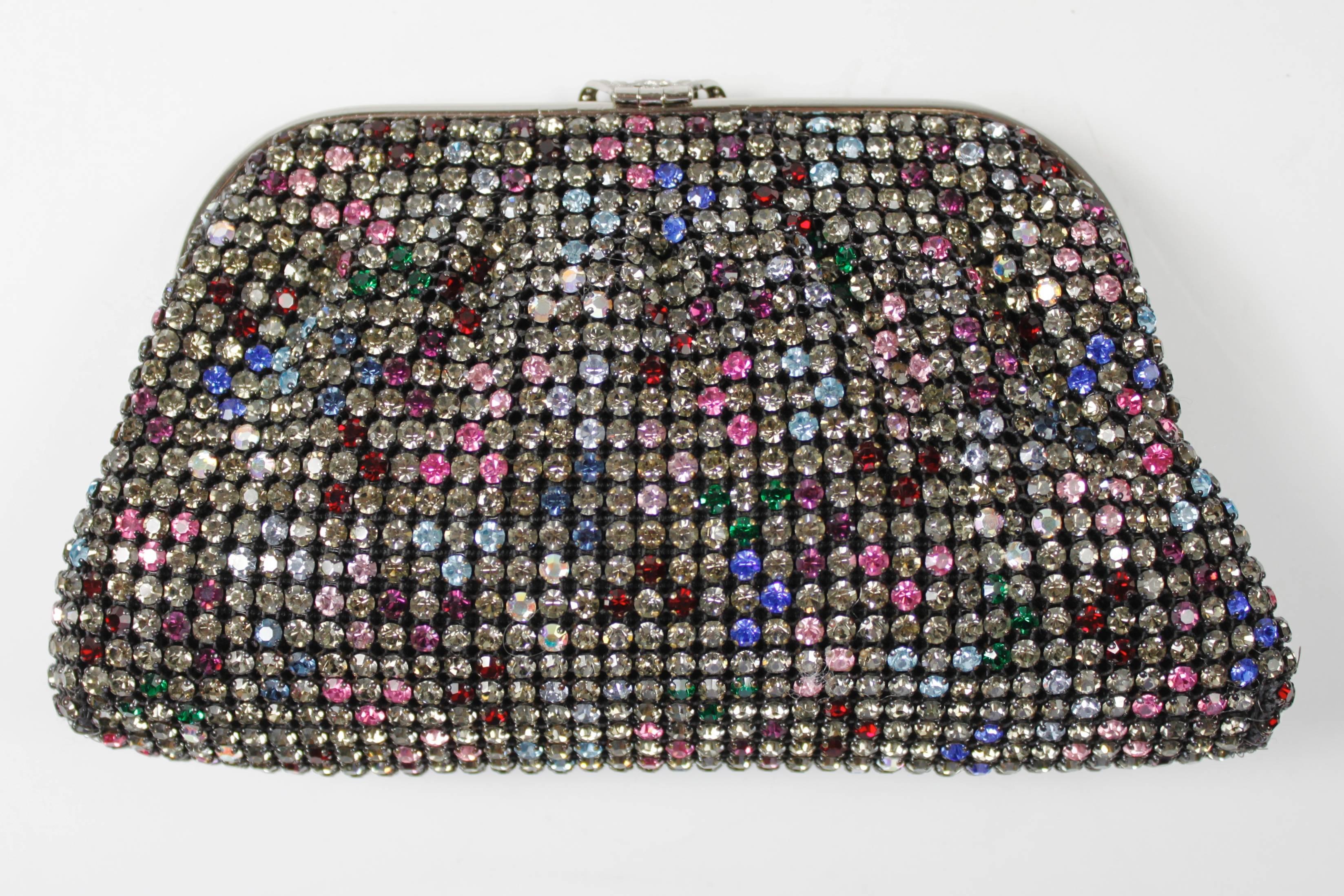 This is the perfect year-round evening clutch: covered in rainbow rhinestones--red, pink, two shades of blue, smokey grey, green, and iridescent clear--it pairs beautifully with most ensembles! The hardware is silver and features a deco-style