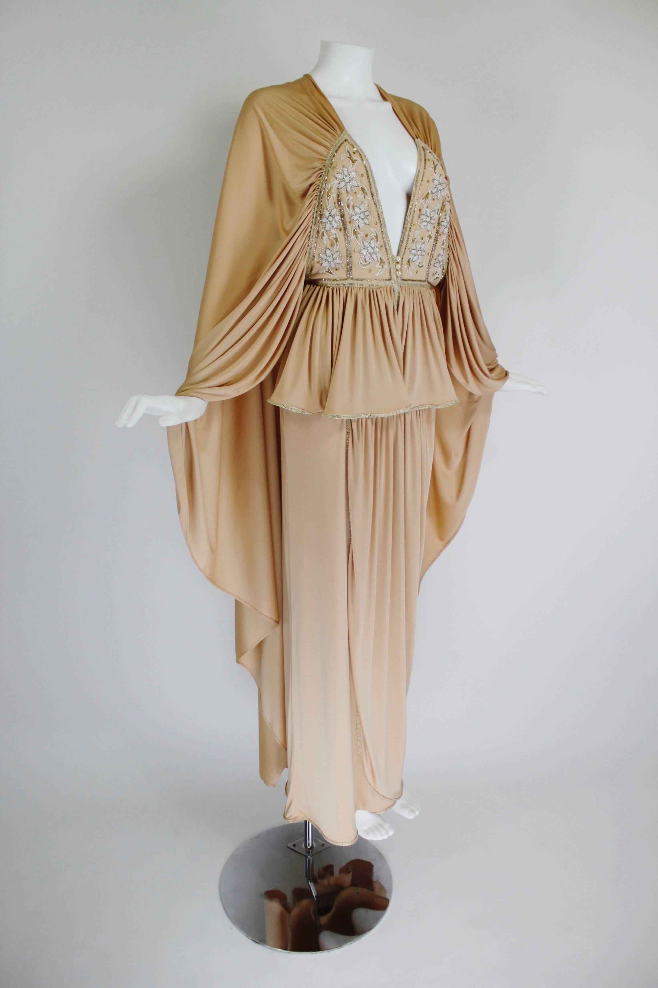 1970s Bill Gibb Ethereal Gown with Floral Beading and Plunging Neckline

*Please note that the fabric is solid nude/beige; because of lighting technicalities, in some images it appears ombré, but is in fact all one color (and rich in