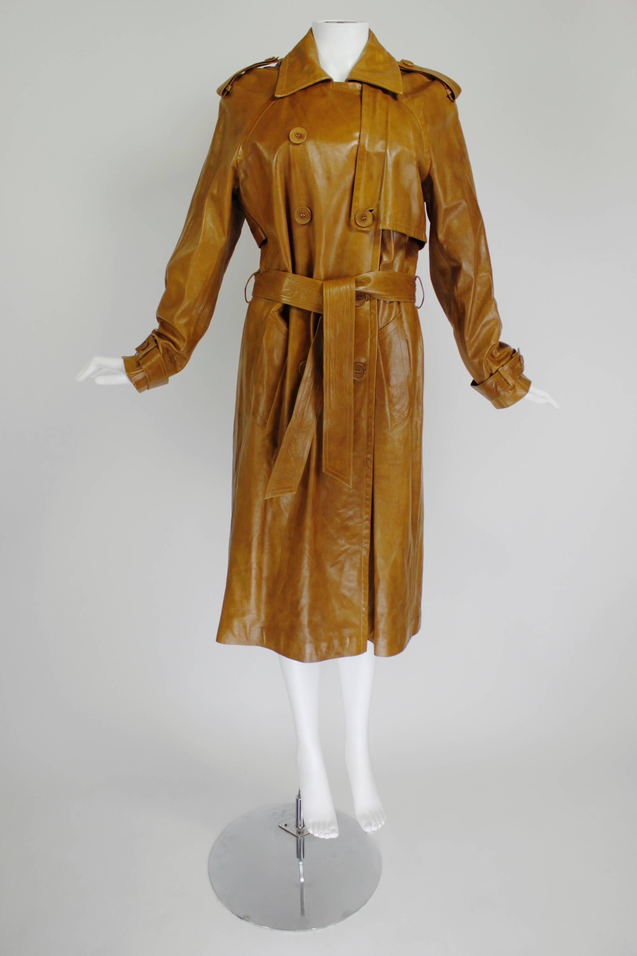 Plein Sud's take on the classic trench coat features luxe caramel leather, double-breasted buttons, and a belt to cinch the waist. Fully lined. 

Measurements--
Marked a size 42/US 10
Bust: 38 inches
Waist: up to 34 inches
Length, Center Back