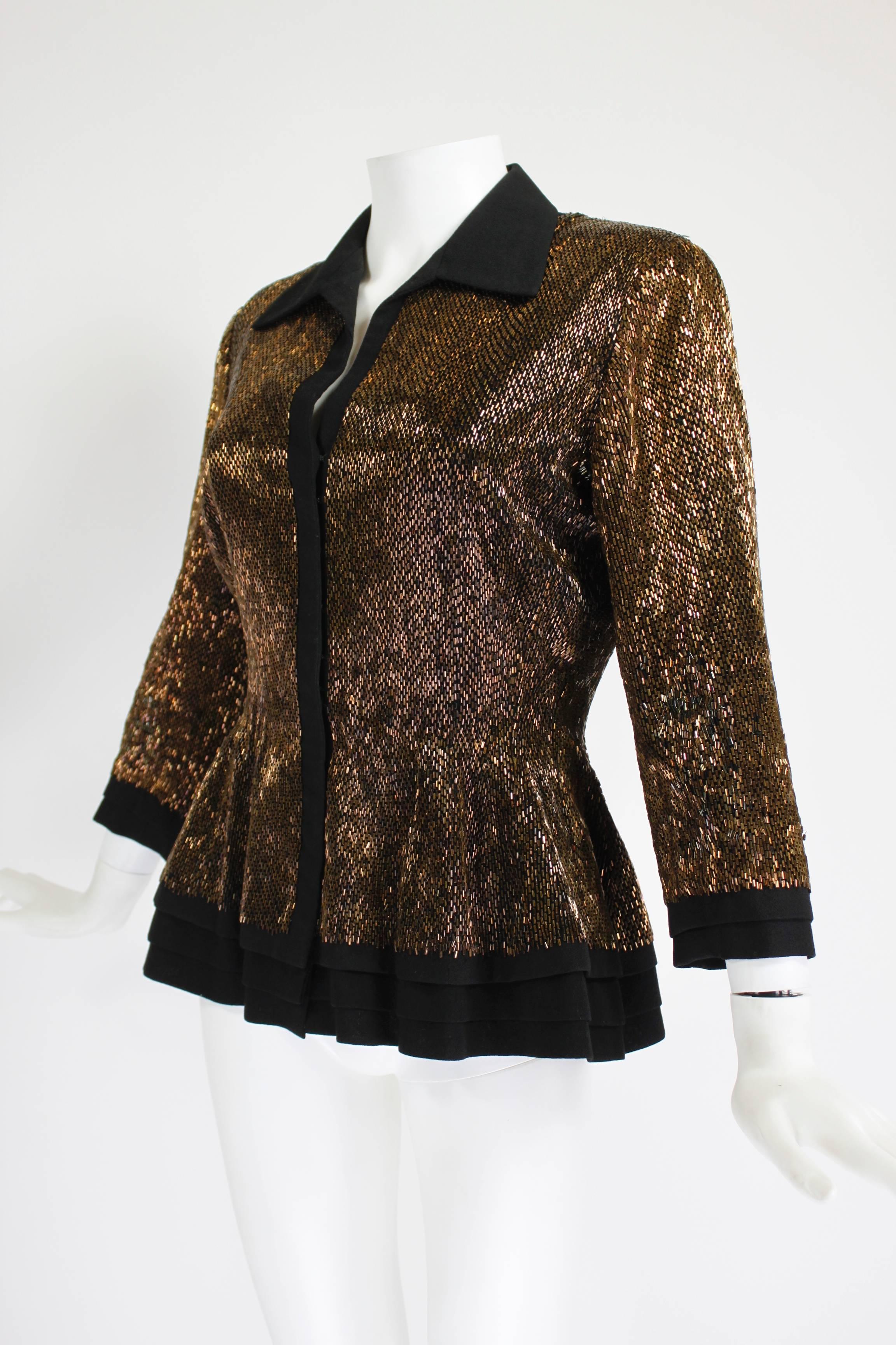 This gorgeous jacket from Balmain Haute Couture features a sexy, tiered peplum silhouette, three-quarter length sleeves, and an open collar. Luxurious wool is covered in iridescent, rich brown bugle beads. The front zipper is hidden with hook and