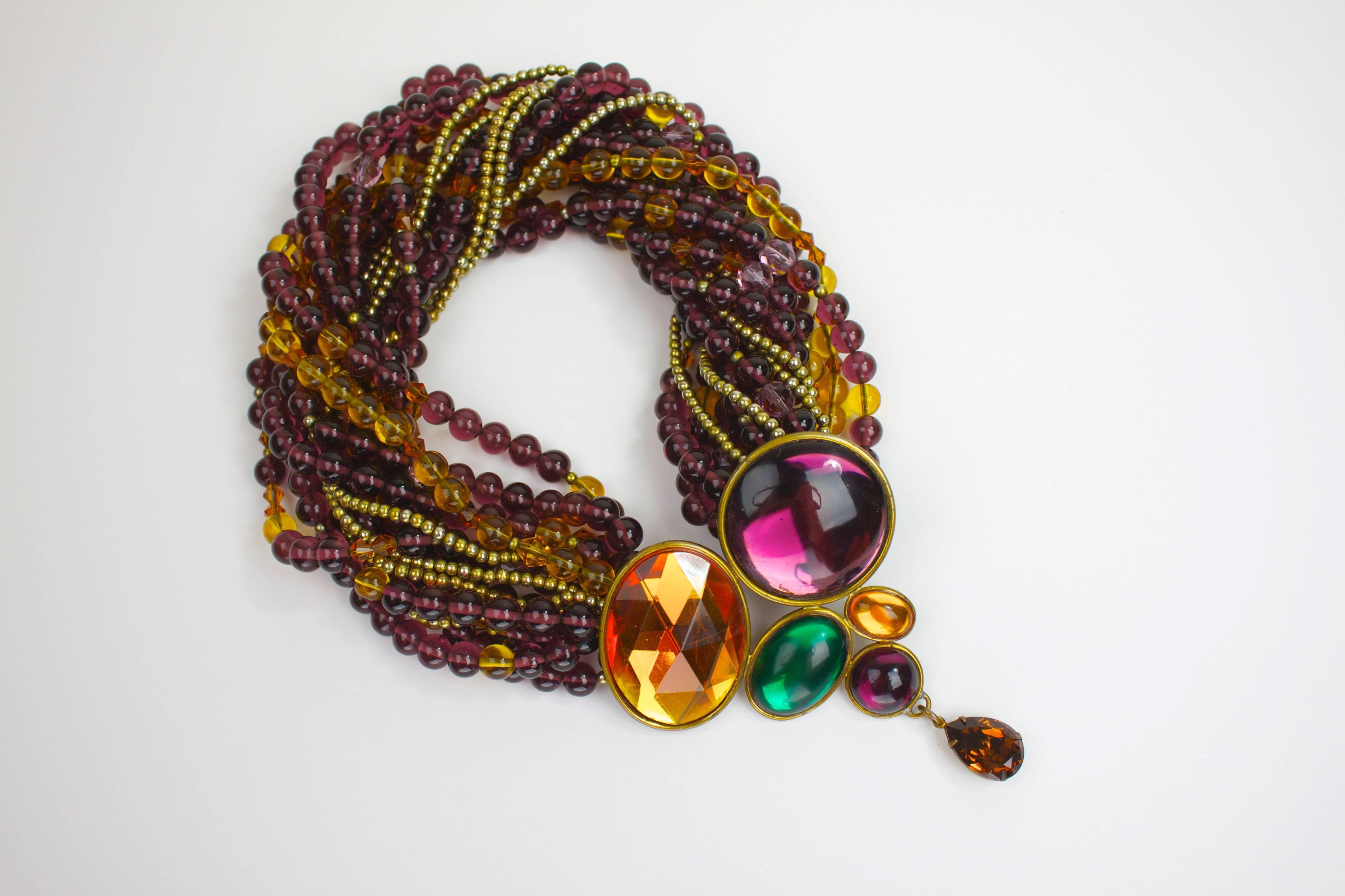 Known for her gorgeous art-to-wear creations for the runways of Oscar De La Renta and Bill Blass, Tess Sholom crafts some of the most gorgeous statement pieces to complement and finish ensembles.

This multistrand necklace--featuring plum, amber,