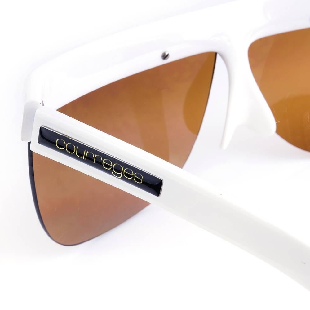 Latter day reproduction by Courreges of their iconic super-mod styled 1960s sunglasses in white plastic and amber toned lenses.