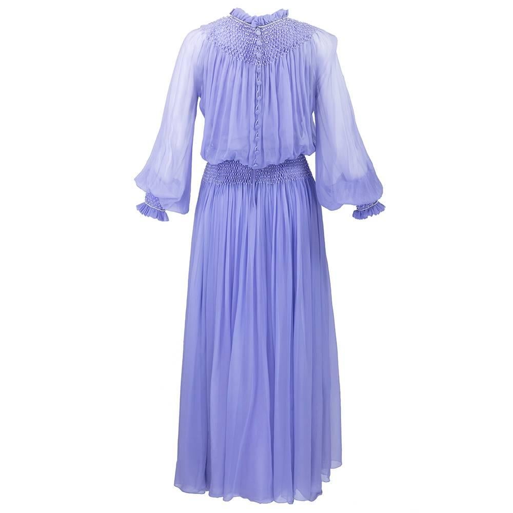 Fairytale lavender silk chiffon full length dress by Nina Ricci with smocked details inset with faux baby pearls. Elongated button cuff and ruffled high neck.  Fully lined.
