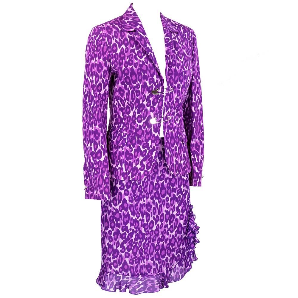 Signature over the top style by Moschino for his Cheap and Chic label. Purple leopard print blazer and matching skirt.  Detachable Oversize safety pin closures. Jacket 100% cotton, skirt 100% silk.  Skirt has a sexy little flounce hem. Both pieces
