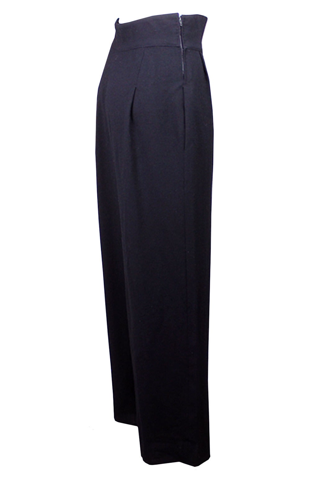 These trousers are beautifully constructed with a flattering line. The high waist is nipped in with a zipper on both sides. The front drapes in three dropped pleats and have deep side pockets. The leg is full and falls straight without a crease.