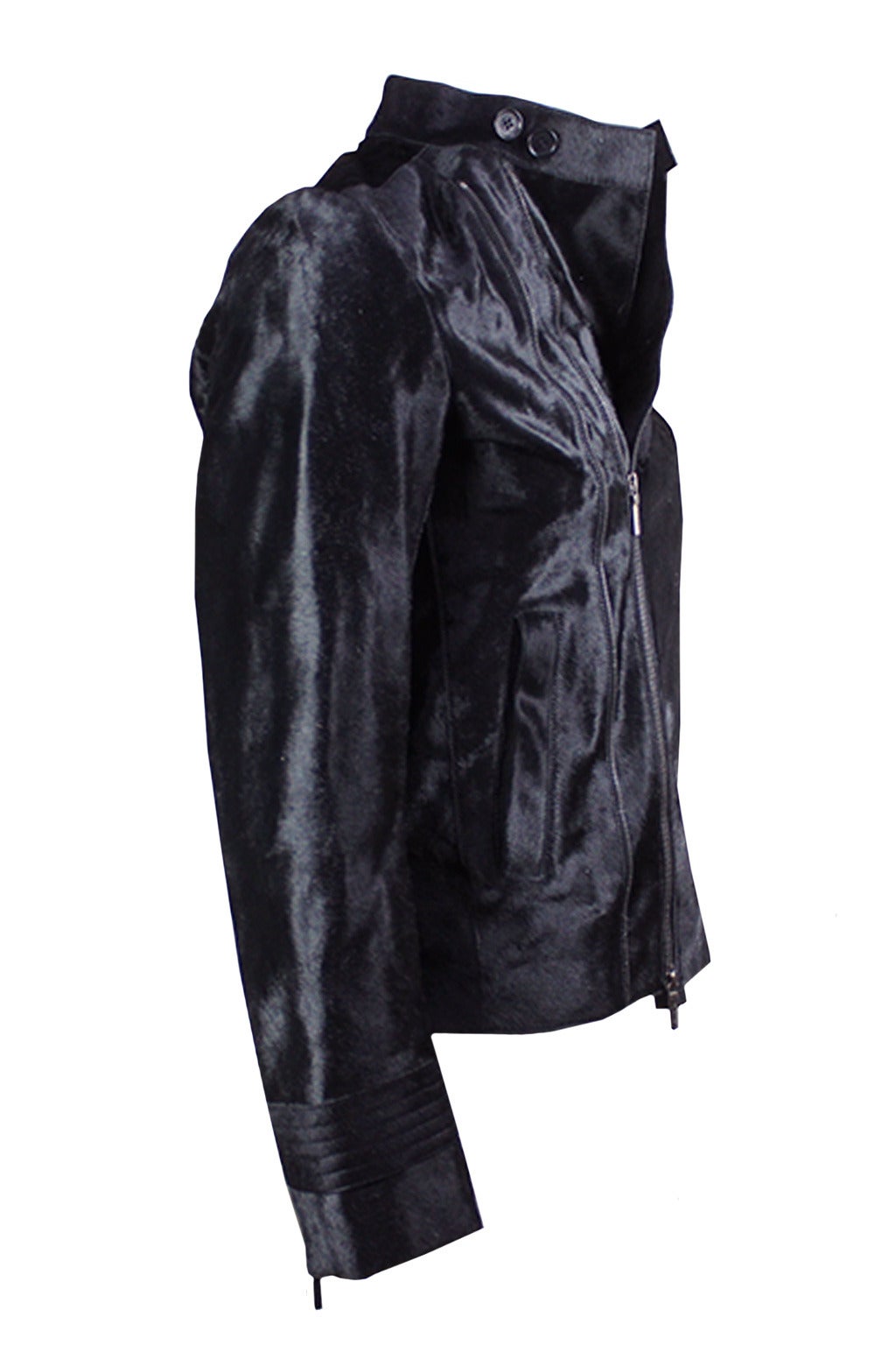 This luxurious black pony hair jacket has motocross styling. The relaxed silhouette has a double zippered front and bold zippers in each arm. The mask closure has two buttons. Other features are a diagonal slash pocket at the breast and two more
