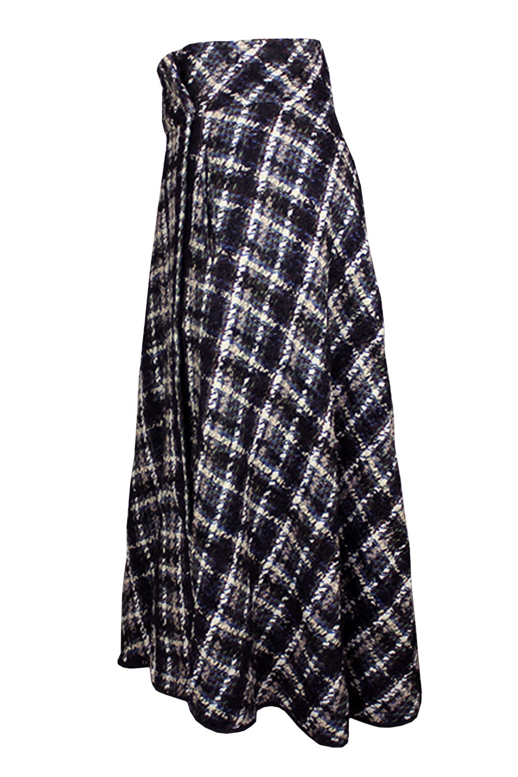 SALE! Originally $695
This elegant skirt has a wide waist band and full skirt. It drapes beautifully with a generous overlap where the fabric wraps, and is fully lined. The plaid is a lovely brown, ivory, black, green, and blue combination.
