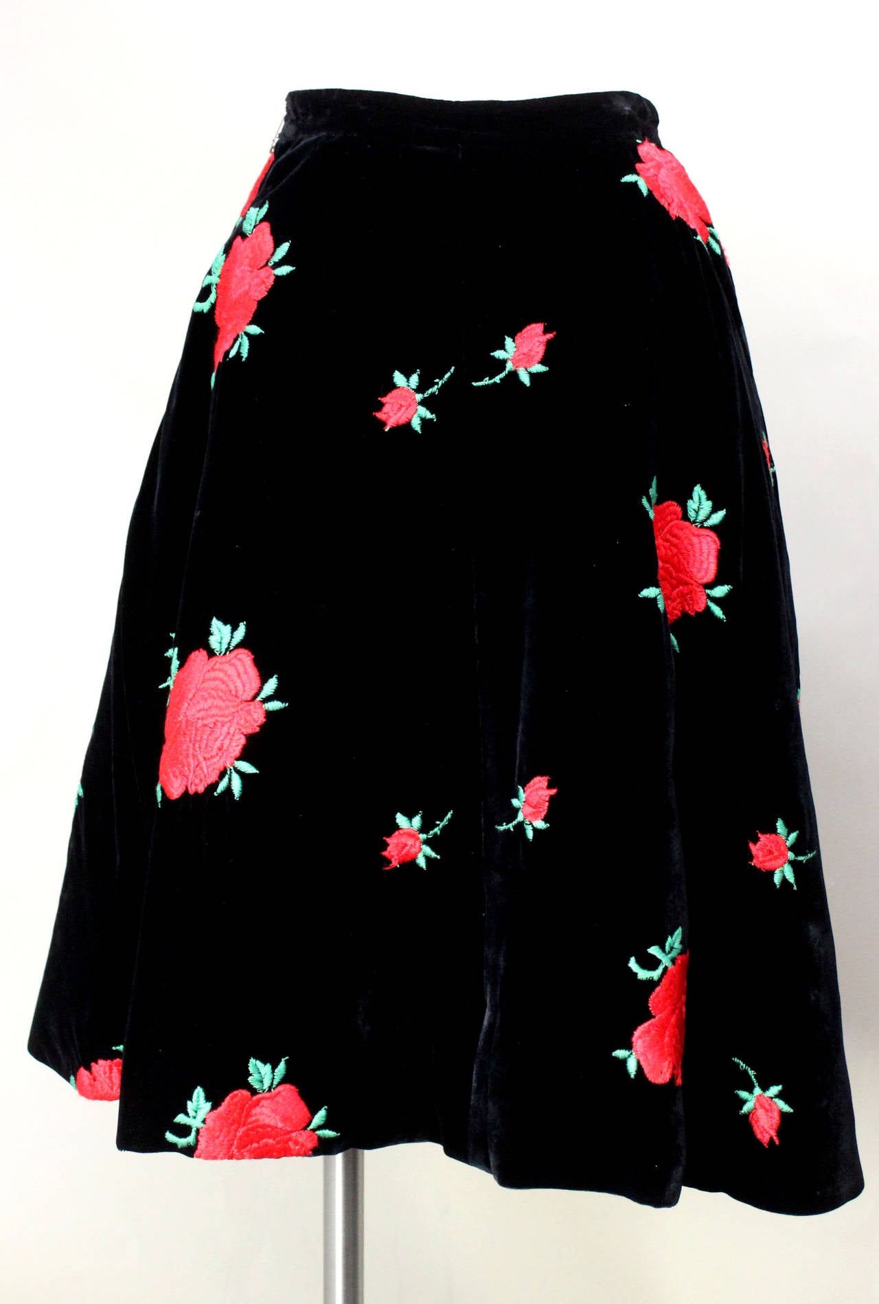This amazing skirt is over 55 years old, but it looks like it was just snatched off the Dolce & Gabbana Fall 2015 Ready-to-Wear runway. The beautifully soft and rich black velvet is dotted with vibrant embroidered red roses. Fully lined in a