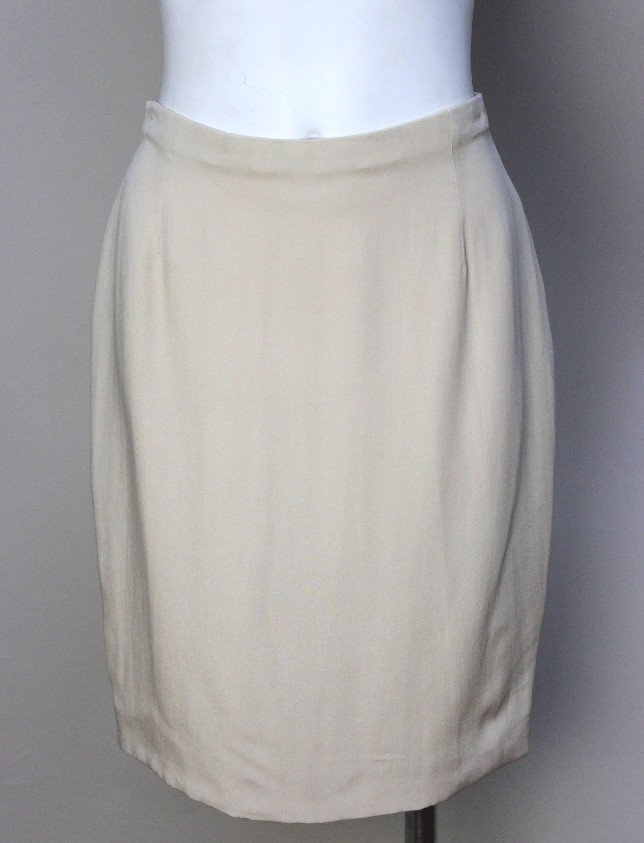 This beautiful light champagne colored silk skirt is a great addition to any wardrobe. The light 100% silk material makes it perfect to wear in warmer weather, and it can be easily dressed up with a blazer or worn casually. 