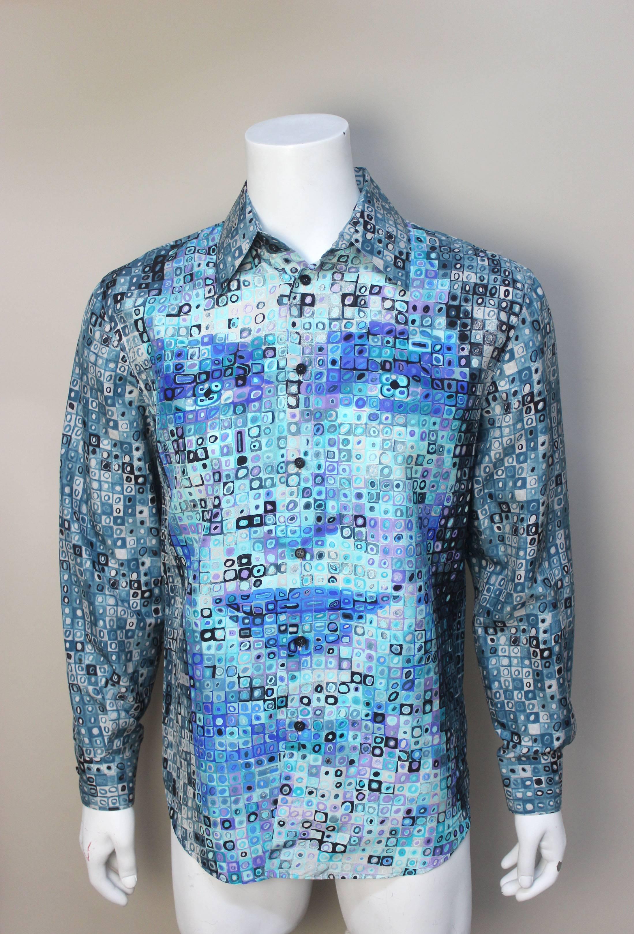 This Versace Couture shirt is a rare find. When viewed up close the pattern is a geometric silk print in blues and greens, but when viewed from afar the face of a beautiful woman (perhaps Donatella) clearly appears. It's an ingenious optical