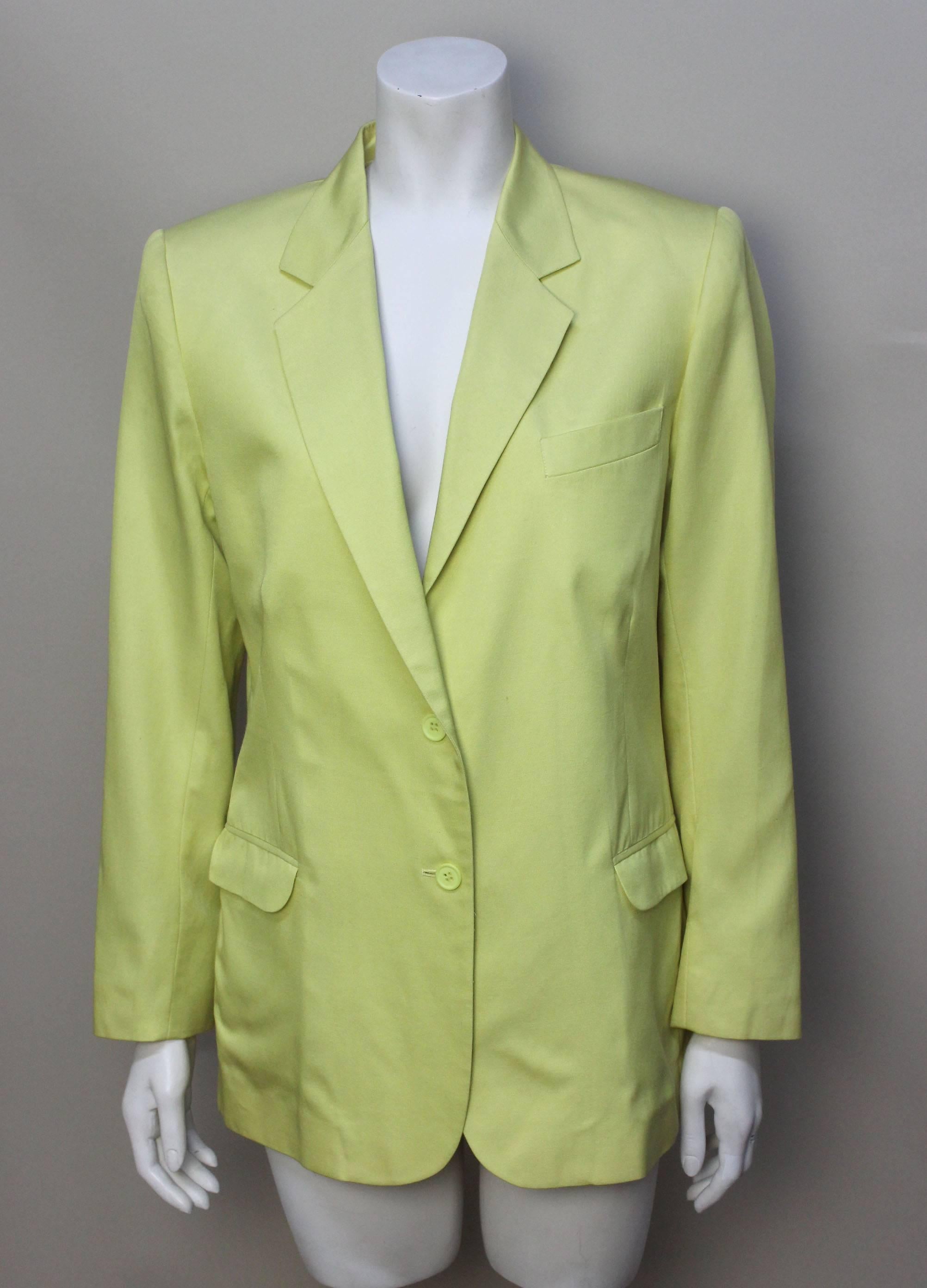 This style of jacket is based on the lines of a traditional mens suit jacket with a peaked lapel, diagonal breast pocket, and two flap pockets. The bright color is what makes it pure Sprouse with its vibrant lemon hue. 