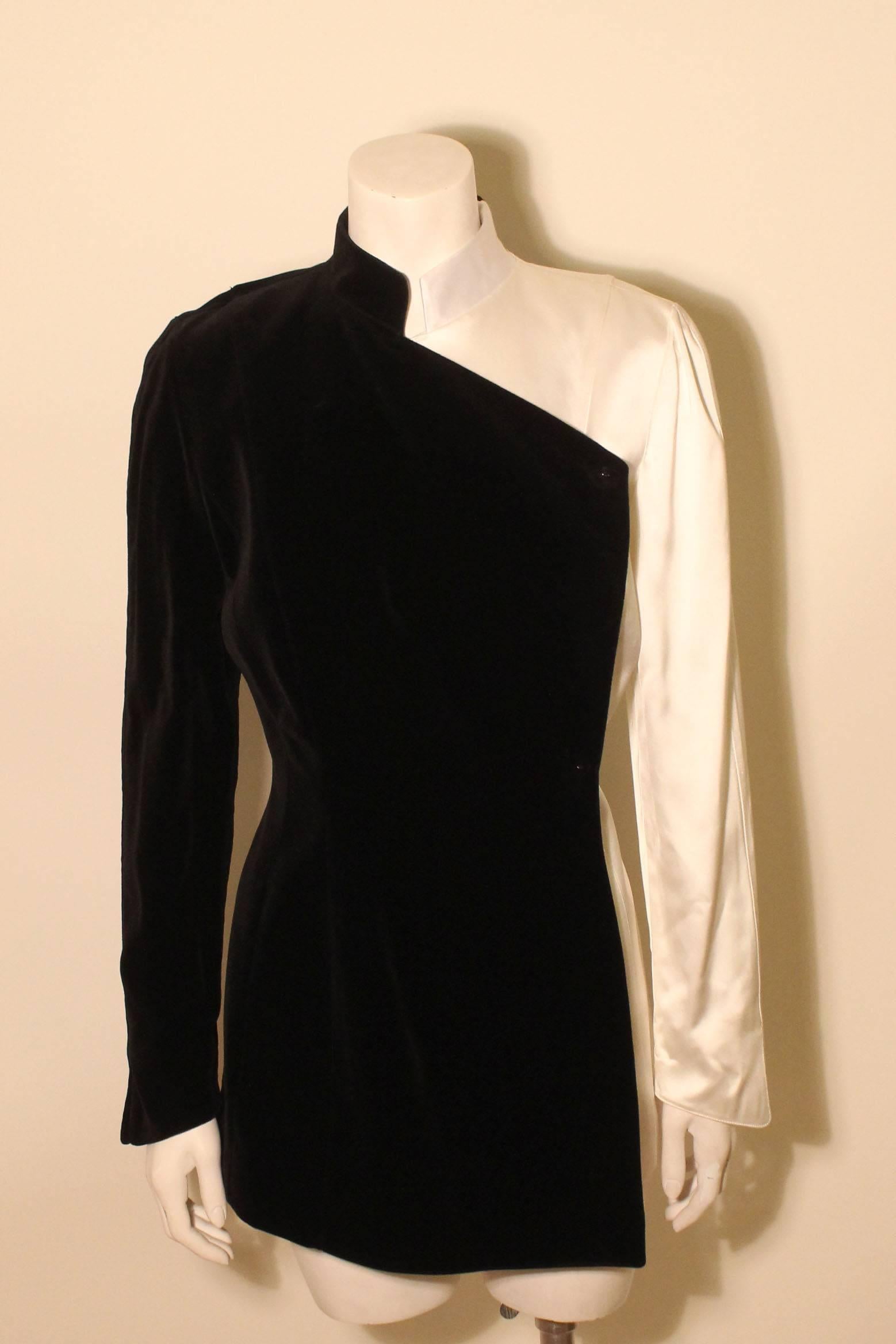 This half white satin, half black velvet Mugler jacket is a knockout. It hugs the body beautifully & the combination of the two fabrics is executed in a flawless, almost architectural design. The shoulders are strong but not exaggerated in an
