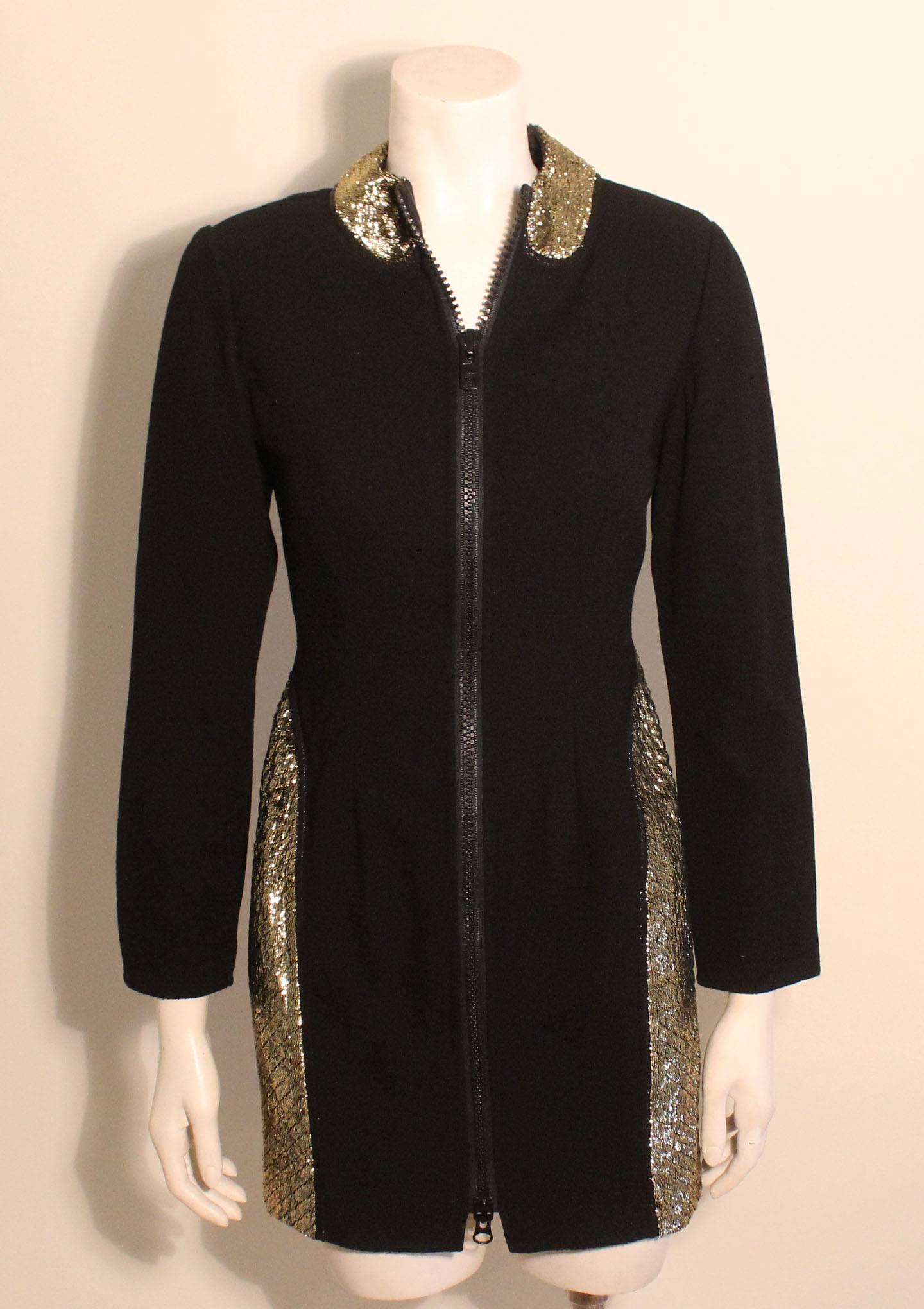 This Geoffrey Beene dress is a perfect example of his designs that often combined sporty elements with luxe fabrics. The tunic/dress is of a fine wool knit fabric with inserts of a gold quilted metallic. There is a zipper running the length of the