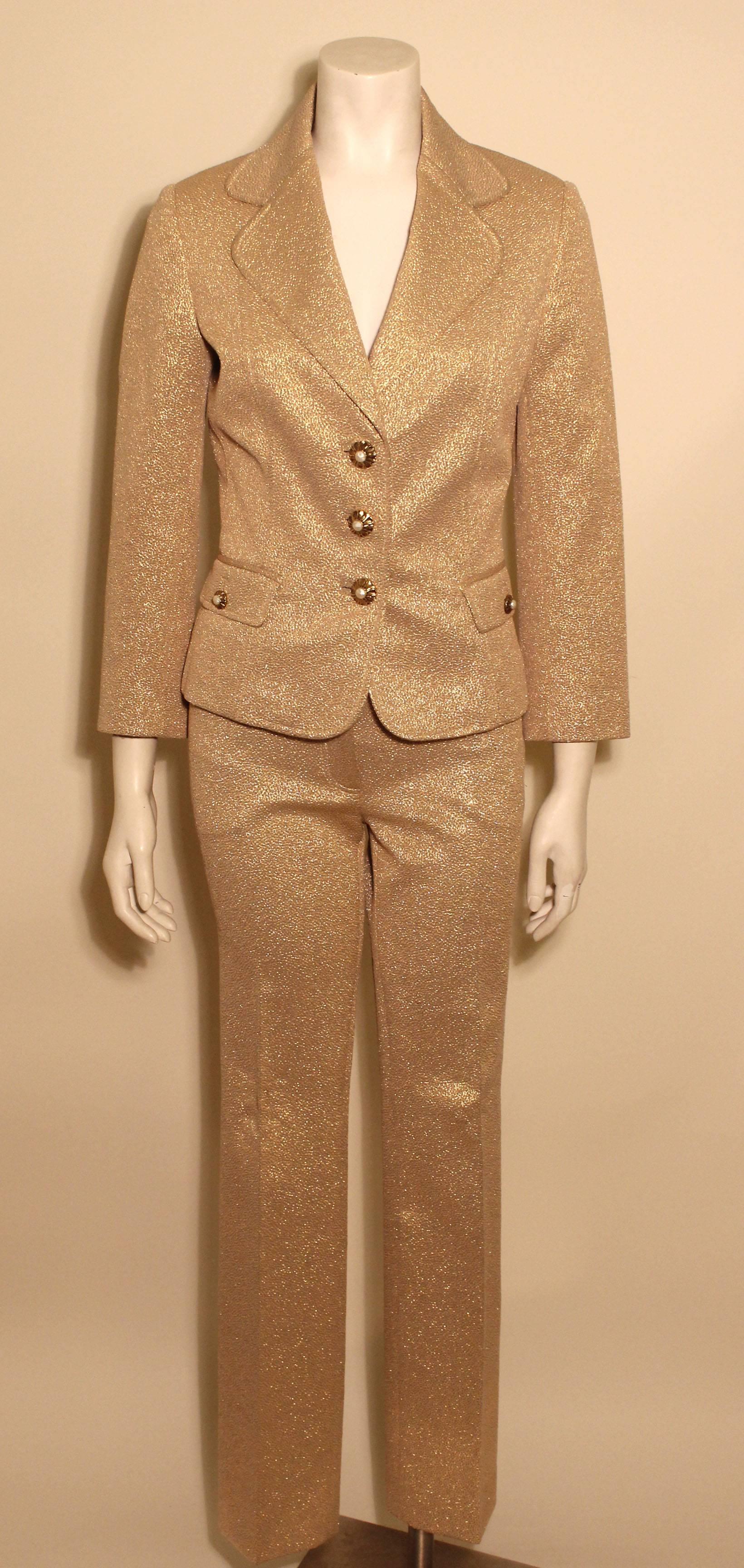 This glamorous gold pant suit is Dolce Gabbana perfection. The straight tapered pants hang low on the hips with wide belt loops and slit front pockets, as well as back flap pockets with buttons. The jacket is fitted and slightly cropped with gold