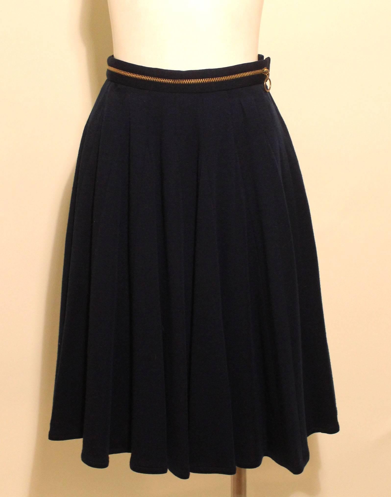 This beautiful navy Geoffrey Beene skirt has a clever design element with a zipper encircling the waistband. Its a fine wool and is completely lined.