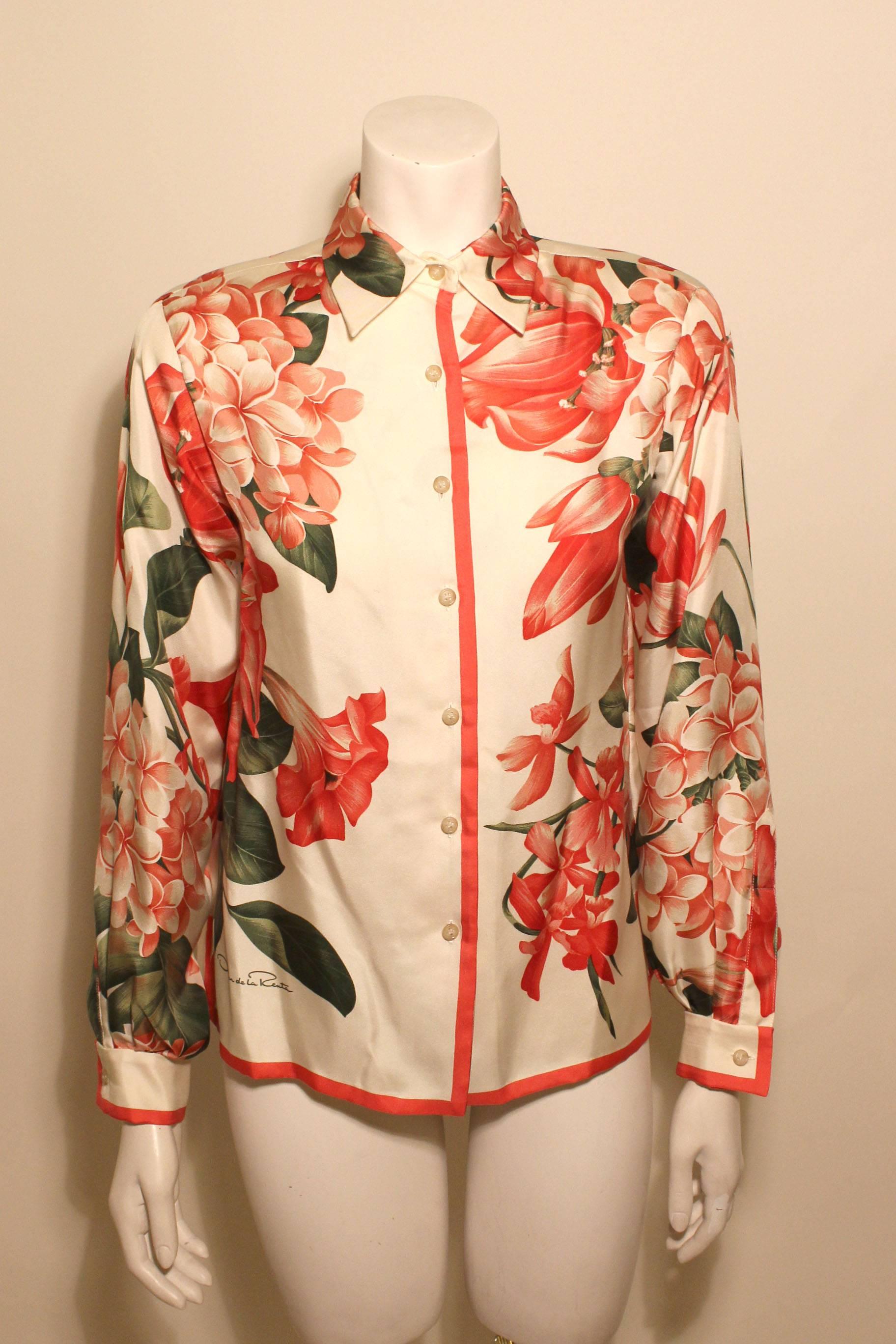 This 1970's Oscar de la Renta blouse has a beautiful pink red tropical floral print on a fine silk. 