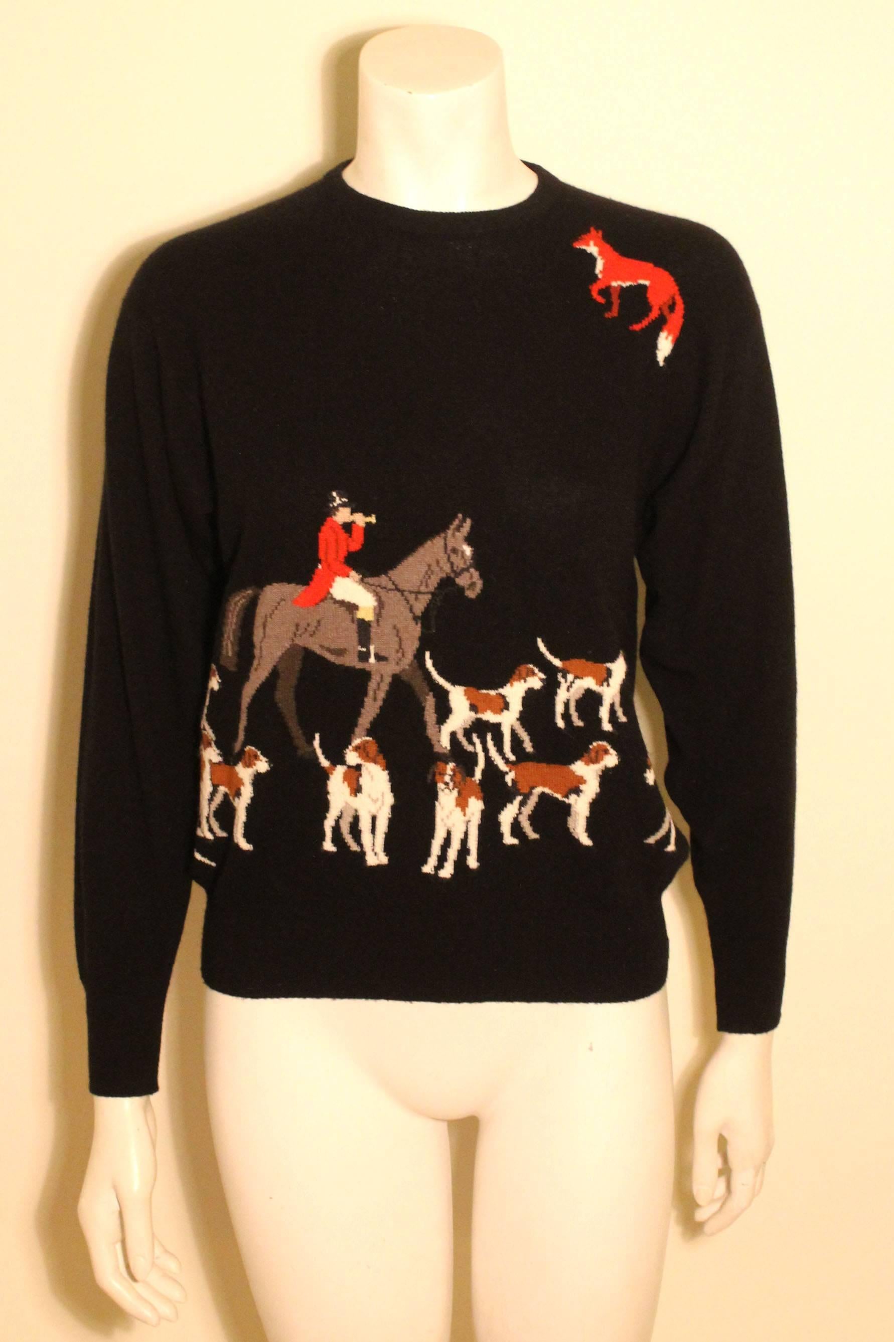 This Ballatyne sweater is of the finest cashmere made in Scotland. It has a whimsical embroadered scene of a fox hunt on the front. 