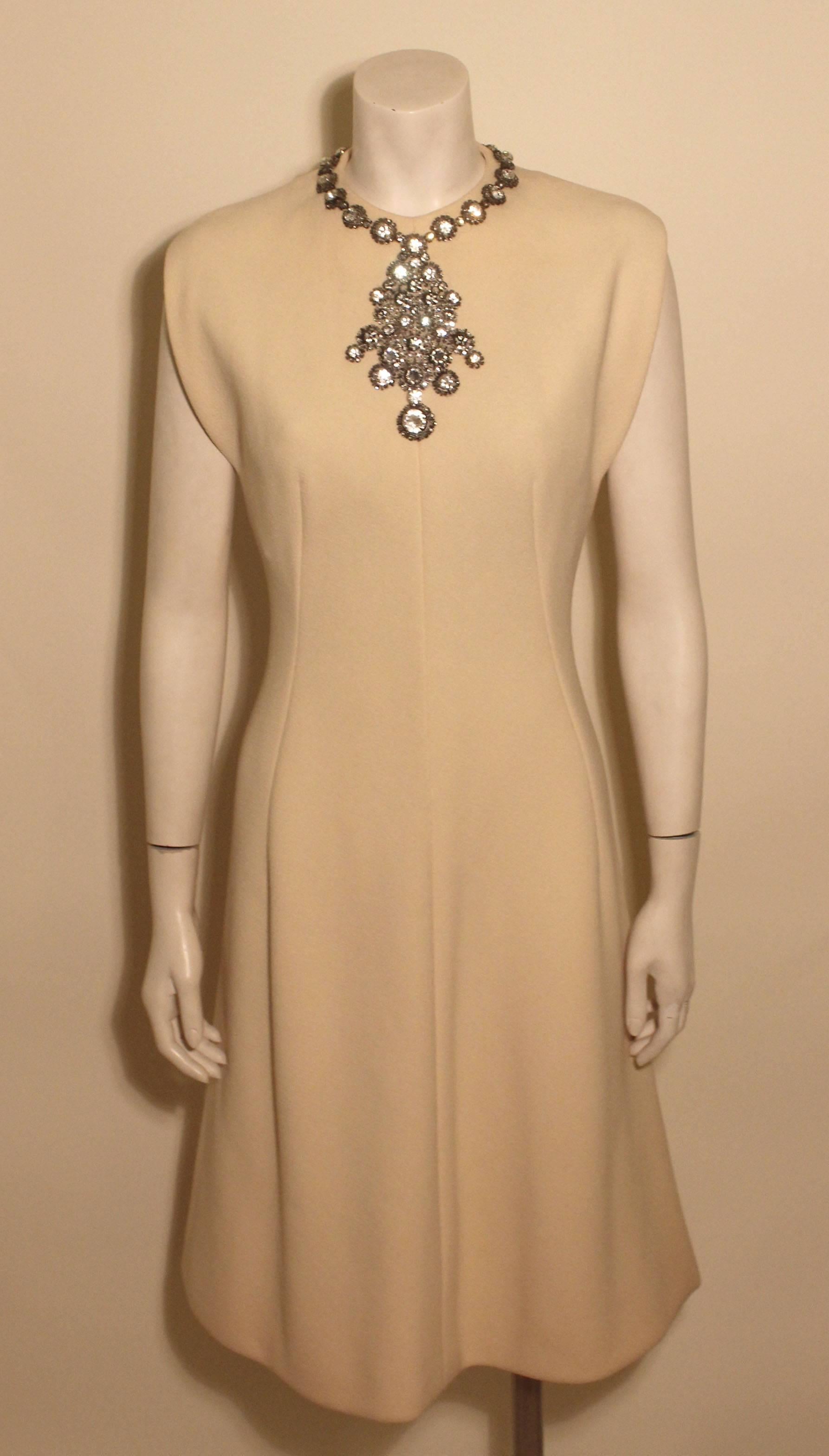 Made of a fine cashmere wool, this Trigere dress is extravagant. It is beautifully executed with a rhinestone necklace attached to the front and neckline of the dress. 