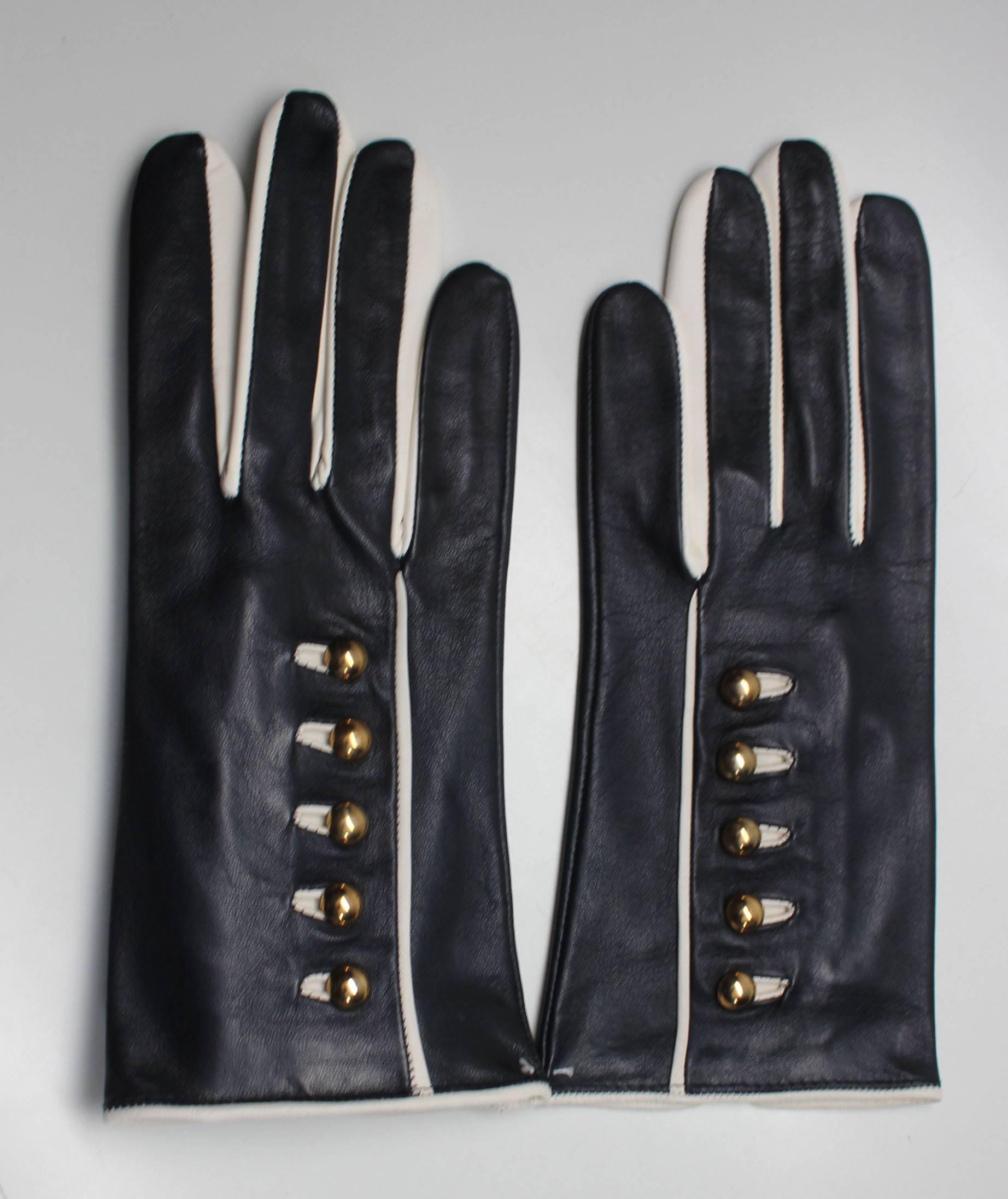 These Escada gloves are chic and the perfect winter accessory. Designed by Margaretha Ley, the navy gloves have white piping and 5 gold button details. Made in Germany, size 7. Never worn, original tags attached. 