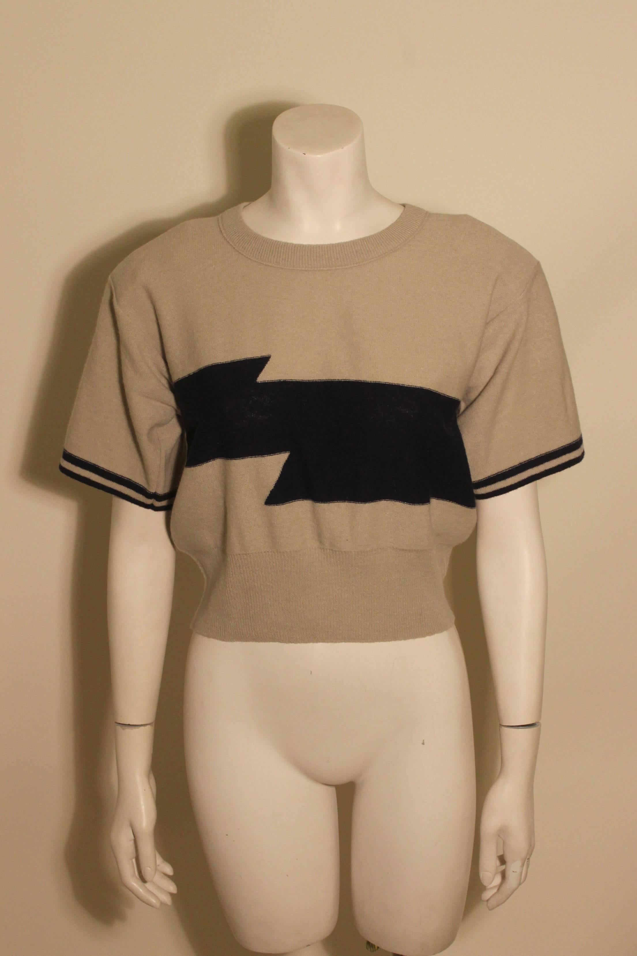 1980's grey short sleeved vintage sweater from Sonia Rykiel with a bold navy stripe across the front, and two stripes at each sleeve. 