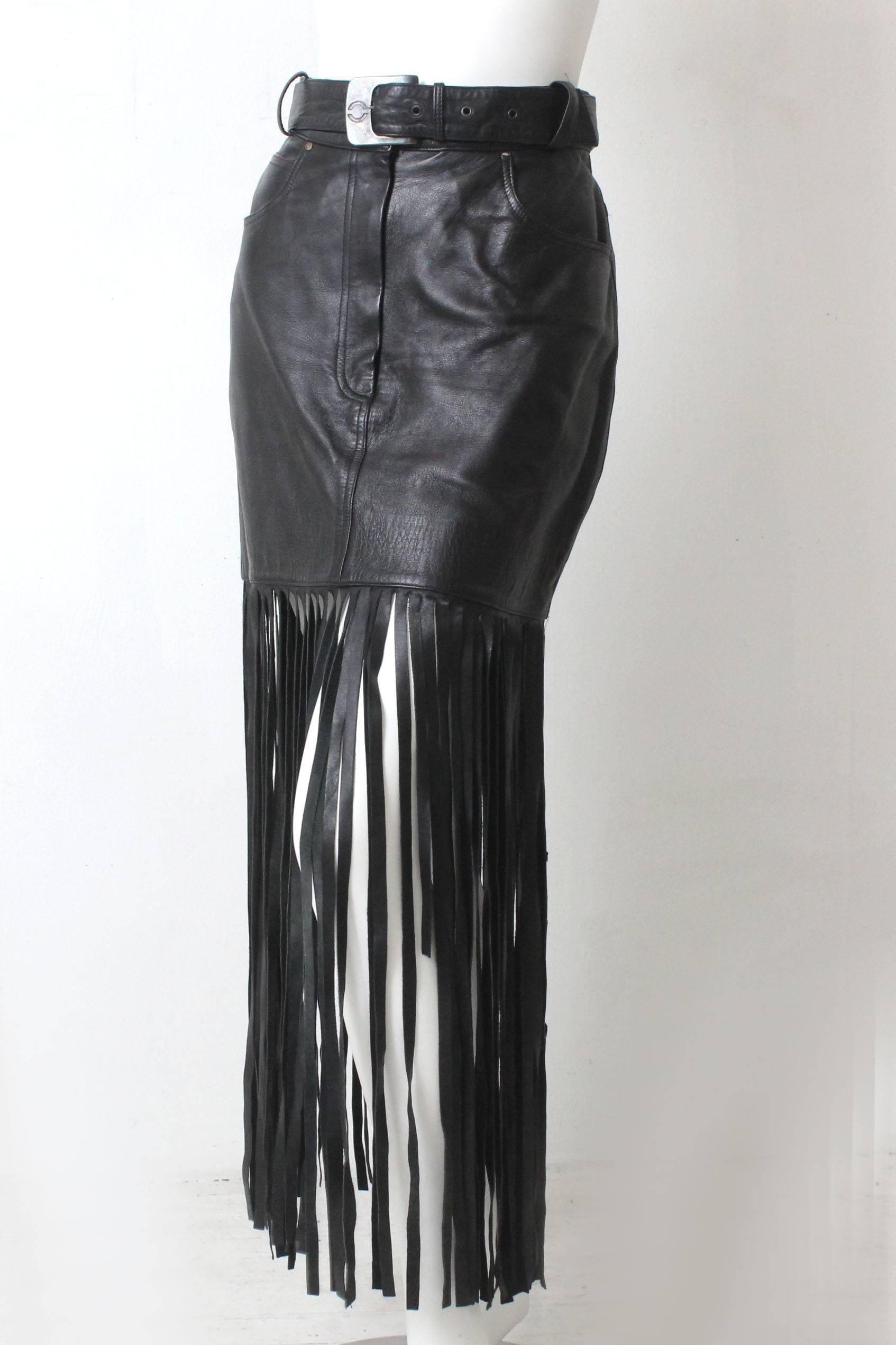 This butter soft body hugging leather skirt is by Claude Montana. It is a very sexy design with floor length fringe. It comes with a matching belt in black leather with a gun metal buckle that is stamped with a Claude Montana C logo.