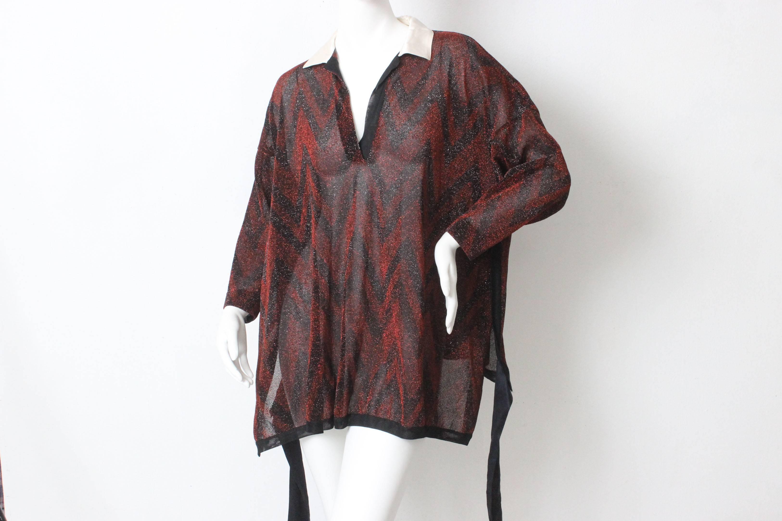 This drapey top by Gianfranco Ferre is made of a beautiful black and red chevron patterned metallic fabric. Ferre often used very lush fabrics with special details. The bottom is edged in black silk ribbon with a matching ribbon attached low on the