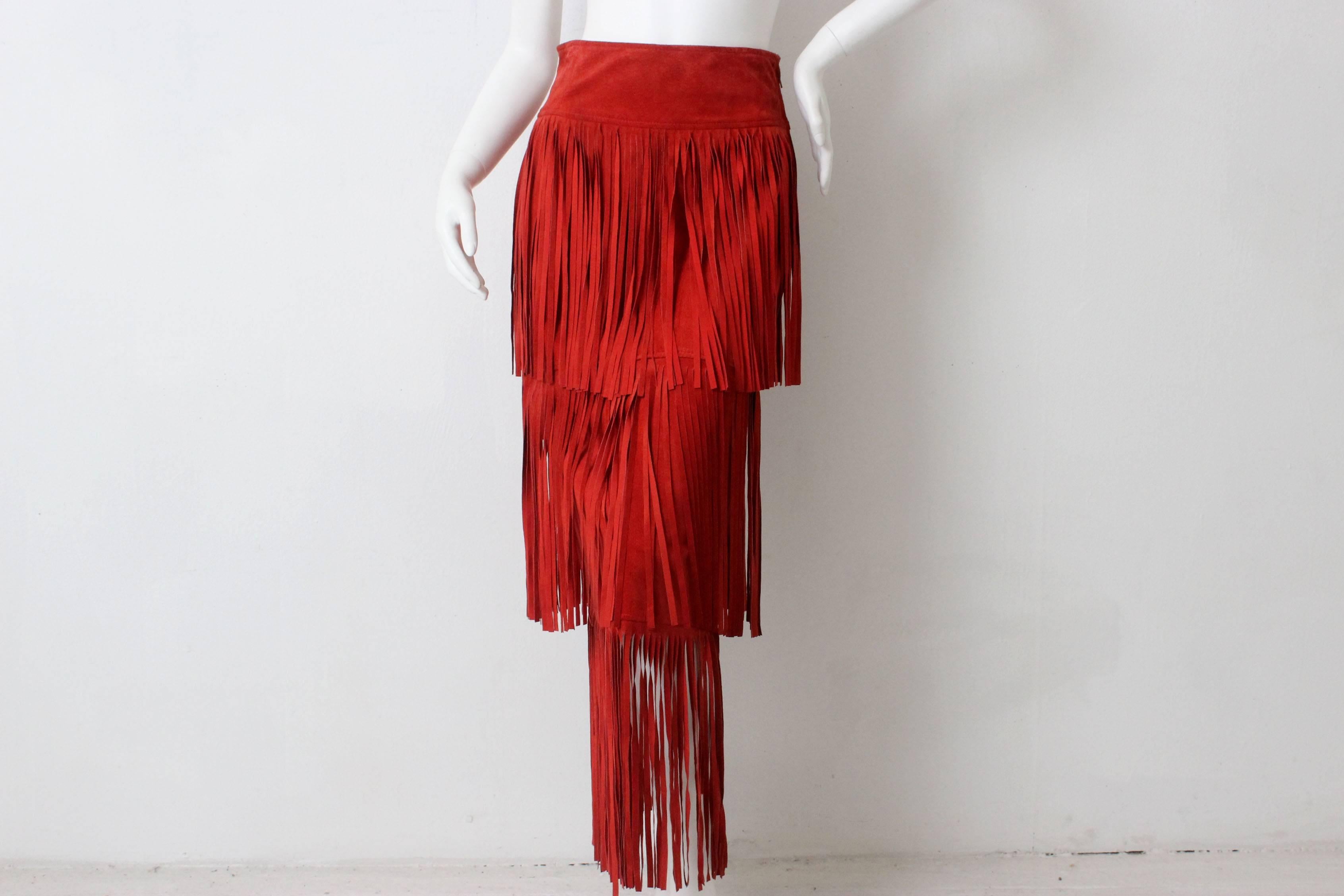 This exceptional Moschino garment is both sexy and fun. Three layers of perfect red suede fringe overlap with the last tier extending to the floor. The fringe is lightweight and allows for plenty of movement. 