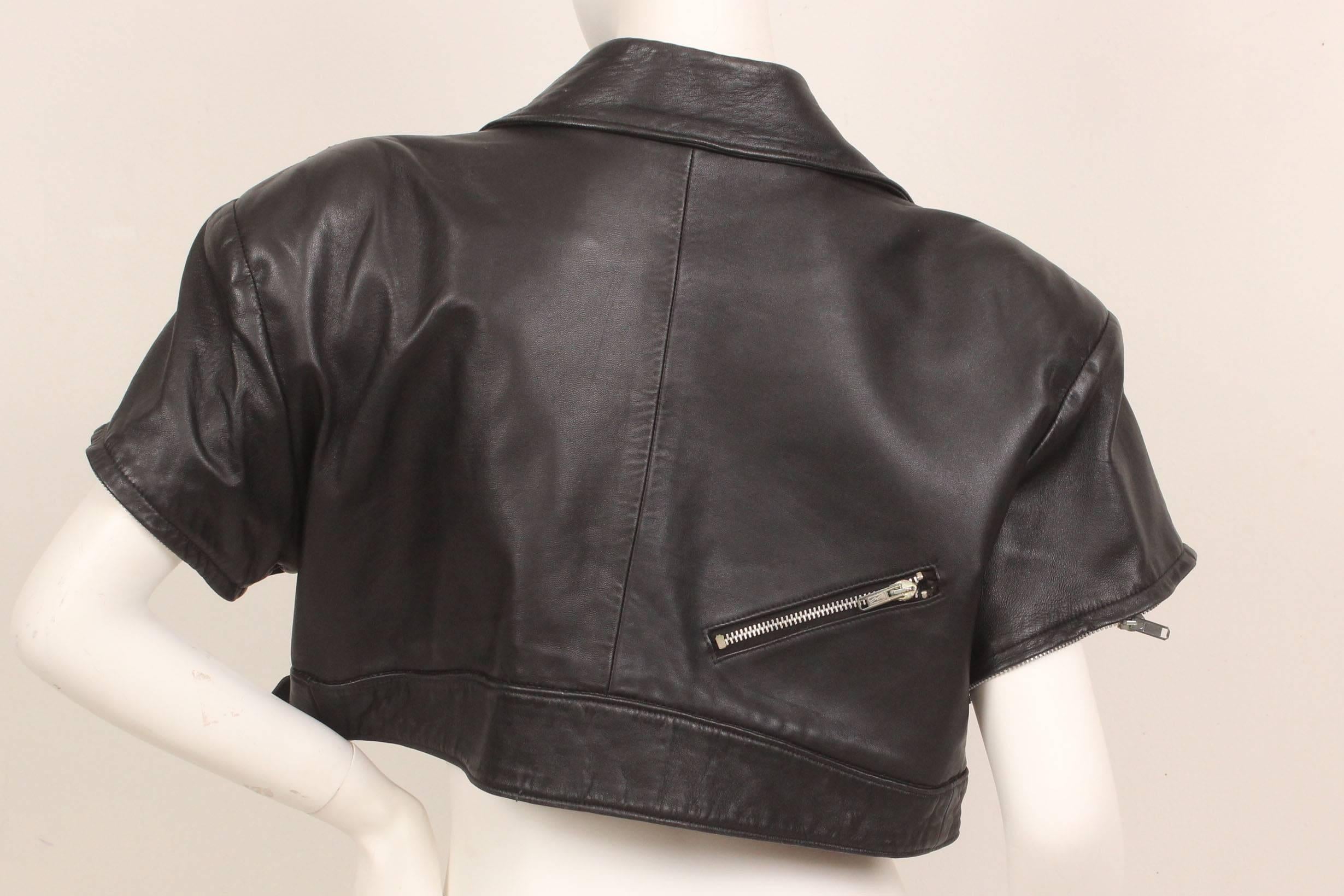 Michoel Schoeler was known in the 1980s for his unique and beautifully crafted garments.  This cropped leather motorcycle style jacket  lined in a vibrant red has great details.  Three zippered asymmetrical pockets adorn the front with another one