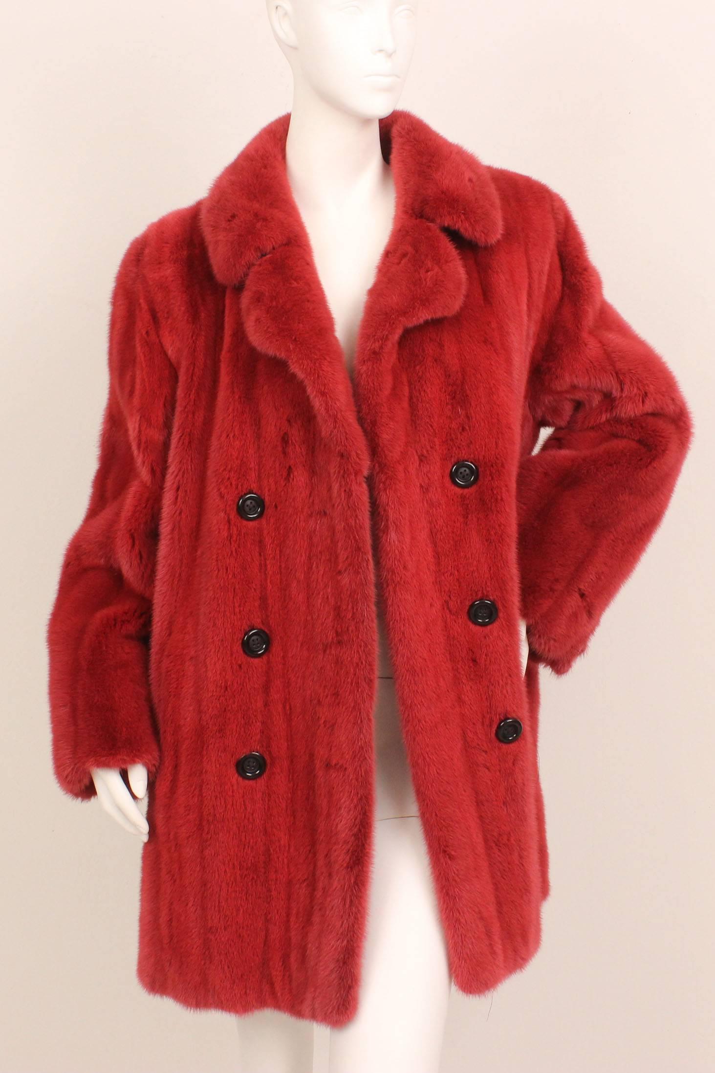 This lovely mink by Ben Kahn is a wonderful addition to any winter wardrobe.  The fur has been dyed a sumptious shade of red. The styling is contemporary along the lines of a peacoat.  It is double breasted with two rows of black buttons down the