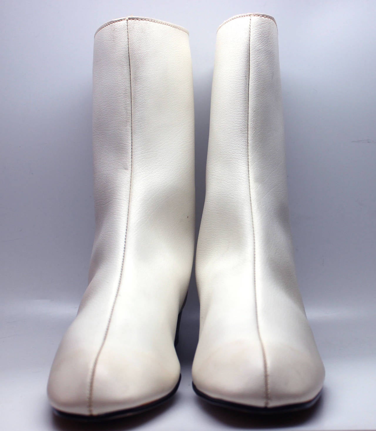 Go go boots were  introduced in the mid 1960s. The original style was
white, low heeled and below the calf in height. The style was called
the Courreges after the designer who was the first to show them and
spurred their popularity. They achieved