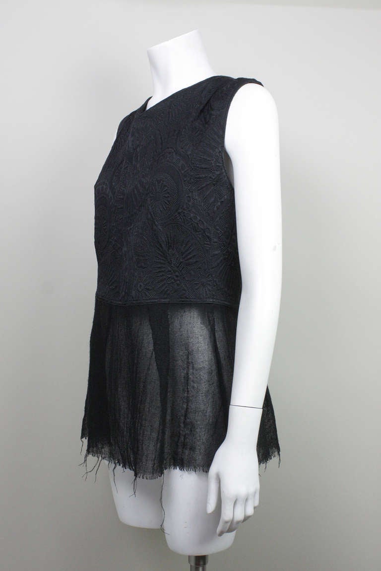 Originally $600
Black brocade vest/top with tie back closure and sheer peplum with unfinished hem. Silk, wool, and mohair fabric.