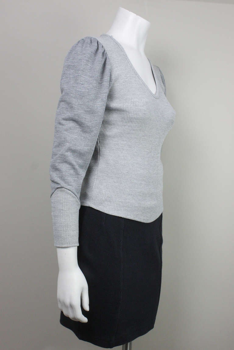 Now on sale! Original price $150

Gray v-neck sporty top with puffed sleeves and sweatshirt inspired details.