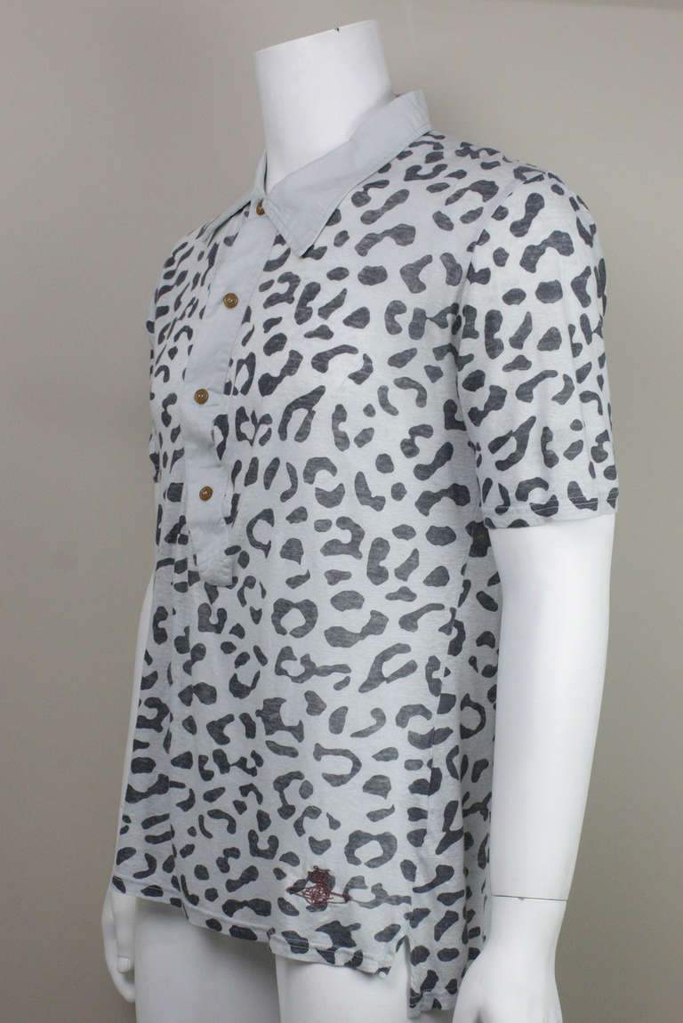 Men's soft linen leopard print polo with a twisted and draping button placket. Embroidered globe logo at the hem.