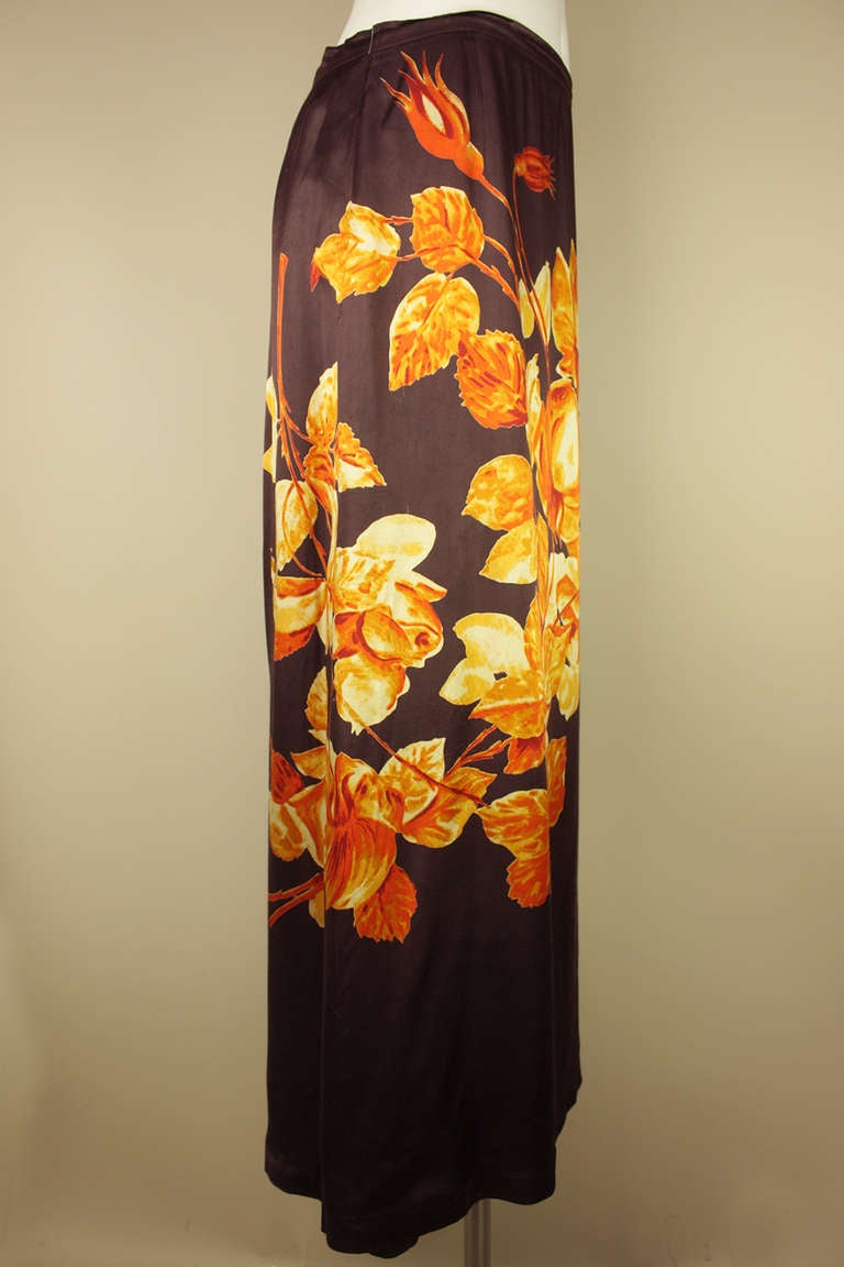SALE! Originally $495
This skirt has a colorful floral print that drapes around the back and has a full slip lining attached. Colors are a deep orange, tan and rose against a brown background.