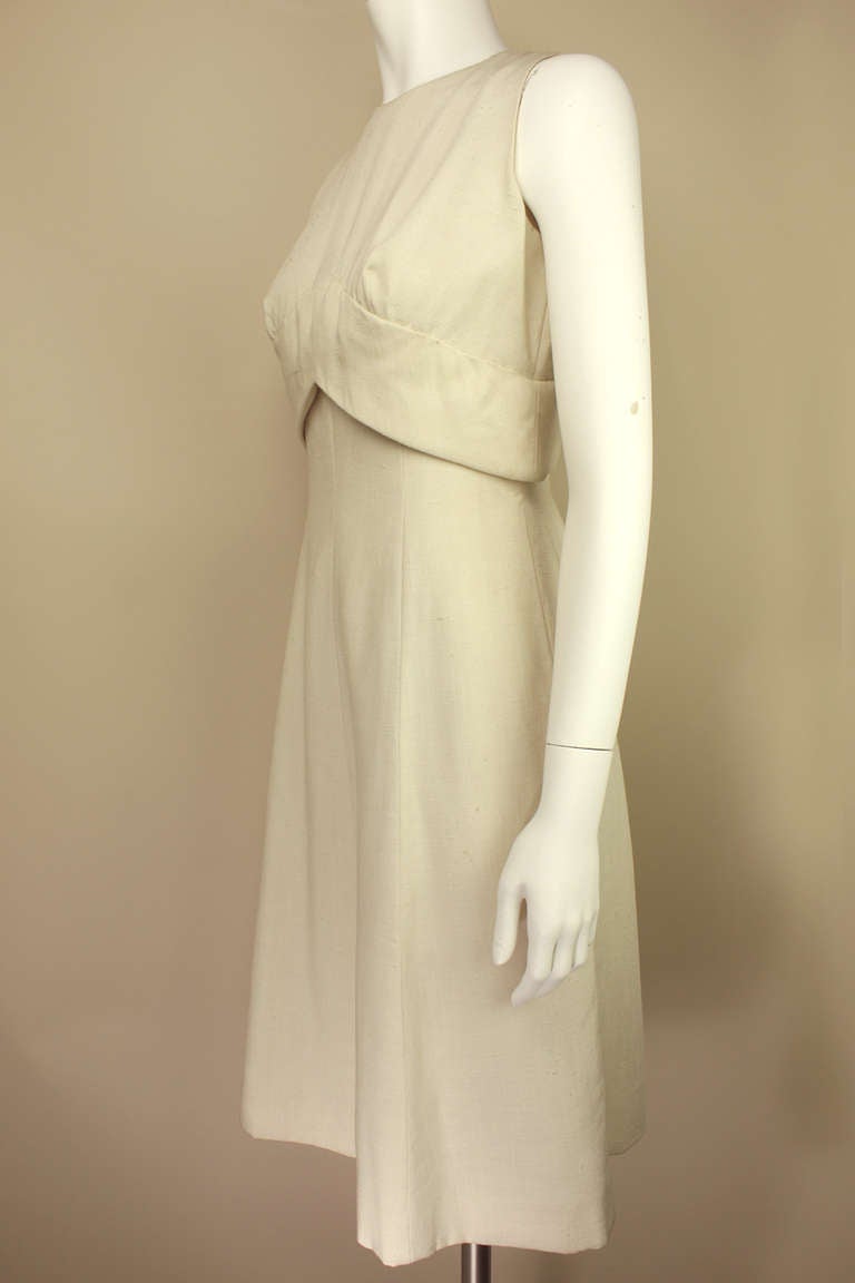 SALE! Originally $495
This is a classic, beautifully constructed Trigere dress, never worn. it is in a nubby vanilla rayon, very chic. It has a fitted bodice that bells slightly over an expertly tailored skirt with a slight a line. A timeless