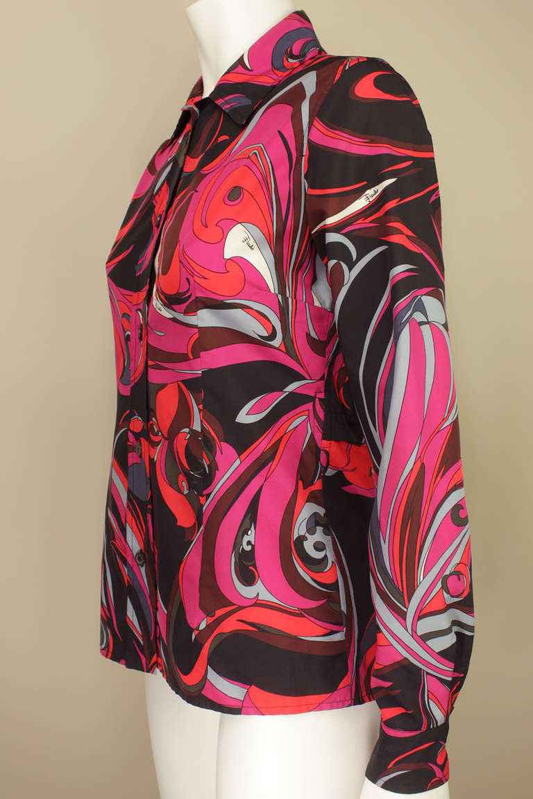 This vibrant Pucci blouse can be folded inside out into an attached pouch and worn around the waist or carried as a bag. A unique feature in a classic Pucci piece.