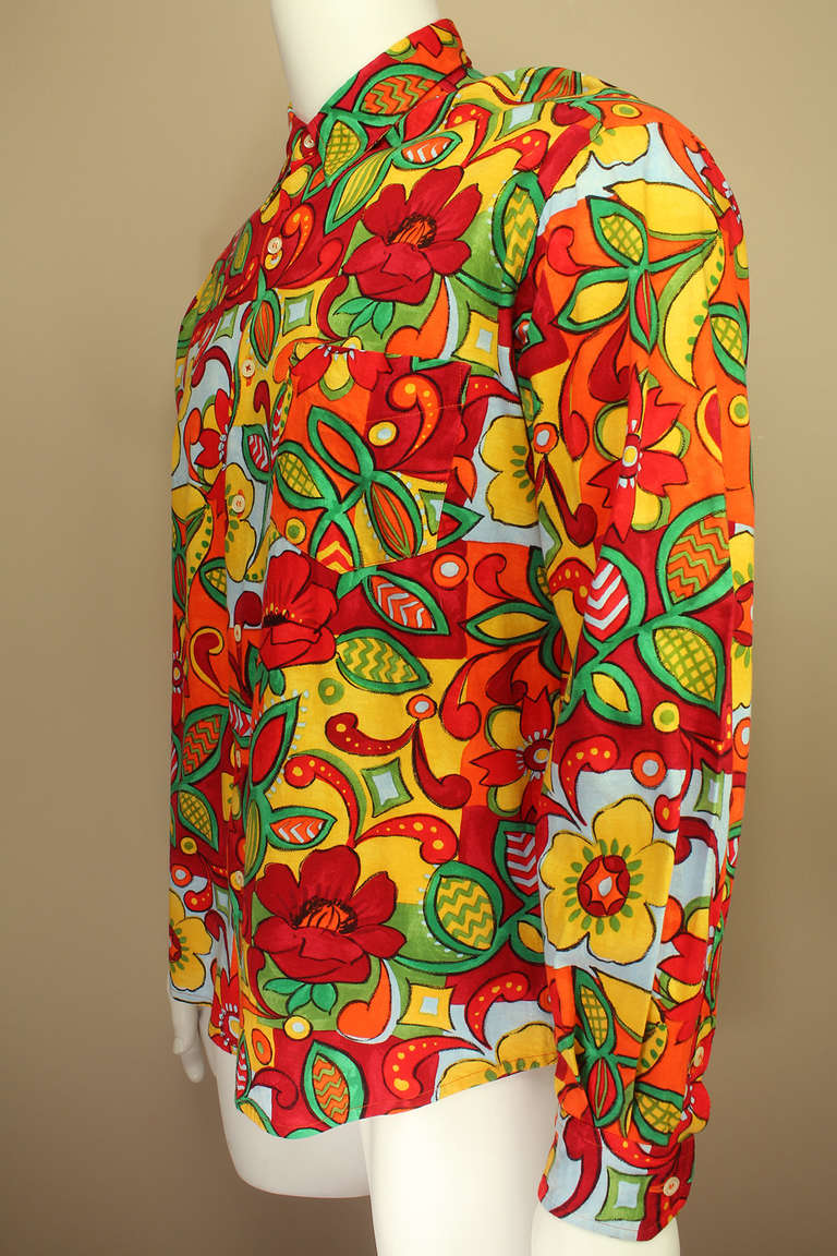 This shirt has an abstract/floral design in bright psychedelic colors with a back logo that shouts MOSCHINOUOMO.