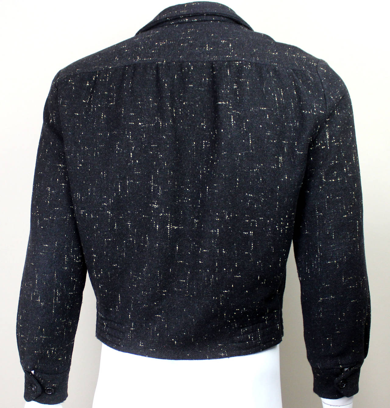 A staple in Ricky Ricardo's wardrobe, these 1950's flecked wool classic jackets are very hard to come by these days. Waist length, zip-up Rockabilly style jacket with a fitted waistband and buttoned cuffs. Two flap pockets adorn the front. The label