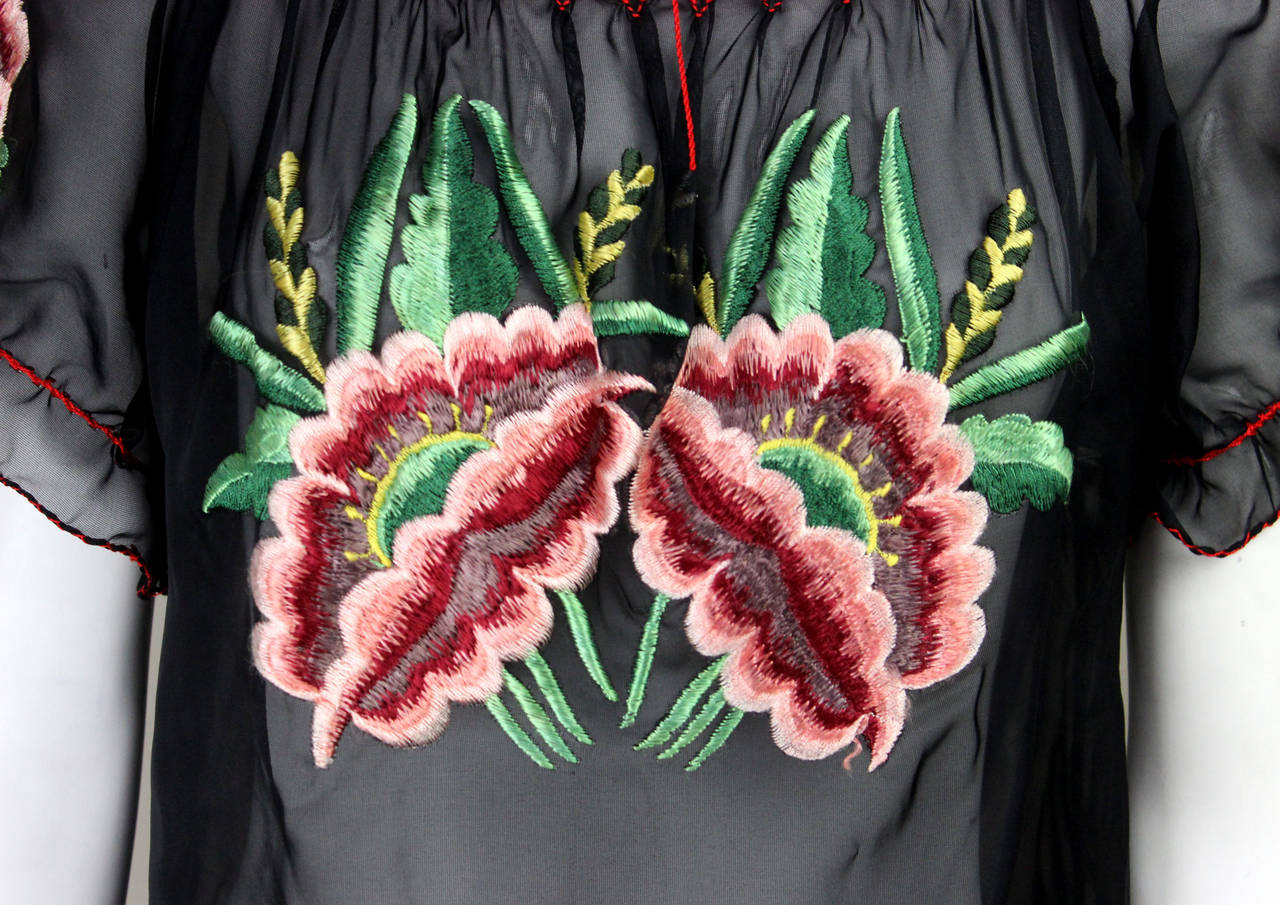 This lovely blouse was purchased in the 1960s at Casa Saucedo, a shop in Aguascalientes, Mexico. Two beautiful hand-embroidered flowers adorn the front and each sleeve. The label reads 
