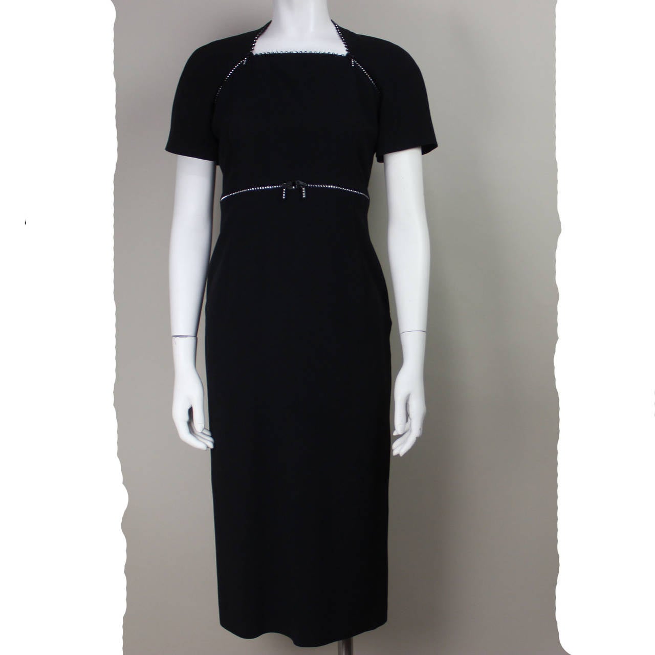 SALE Originally $350
This unique dress by Krizia features working rhinestone zipper trim along the neckline, sleeves, and waist. Clever and sexy, this detail takes the little black dress to an elevated level of stylishness.