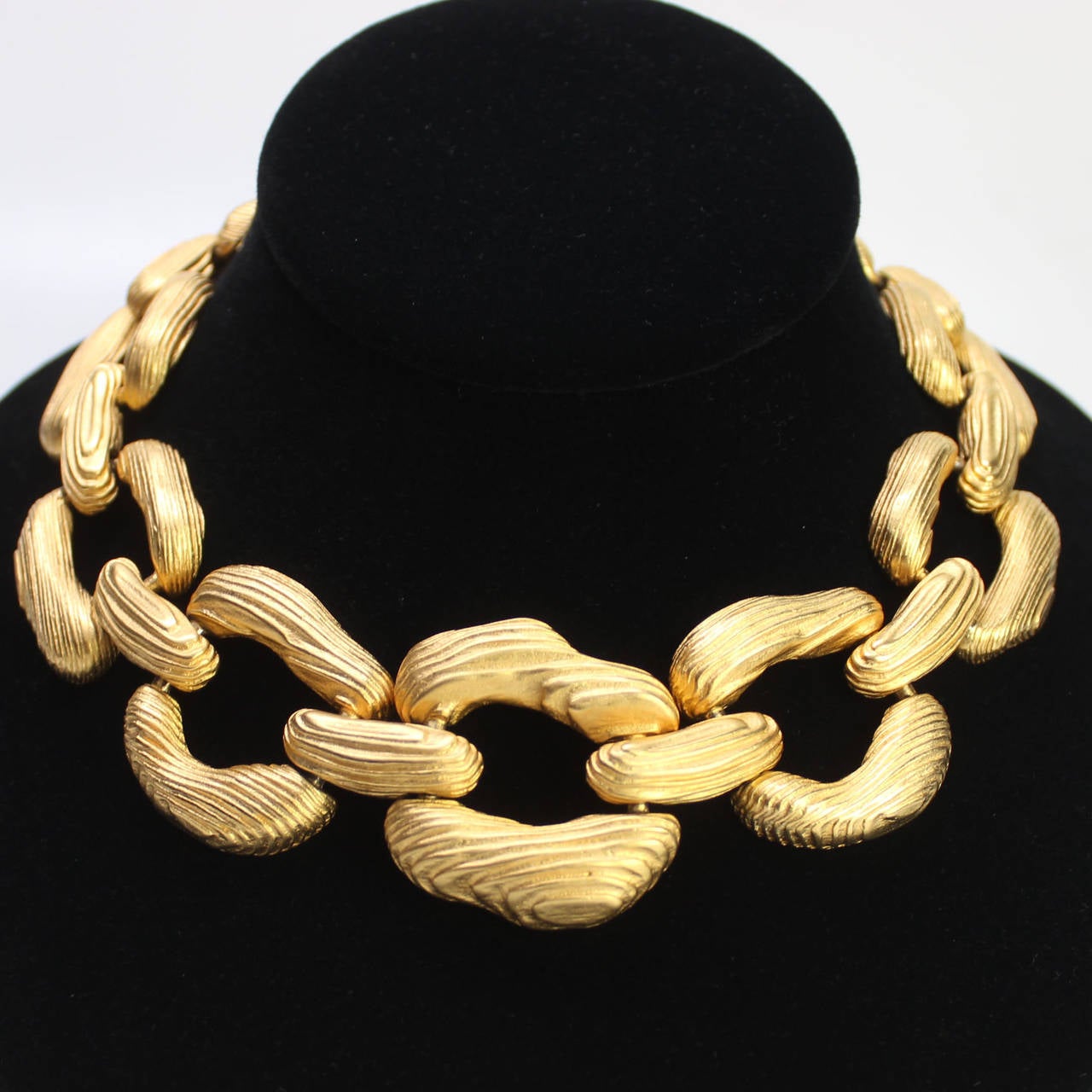 This handsome Givenchy necklace makes a bold statement.  It has an interesting wood grain texture fabricated in a sumptuous gold gilt metal.  It's the perfect bold accessory to make any outfit a hit!