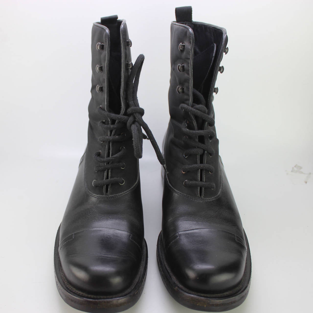 SALE! Originally $295
These are classic Prada sporty lace-up boots with a combination of leather and nylon.  The shoe is made of sturdy leather with a treaded sole, and laces up the front.