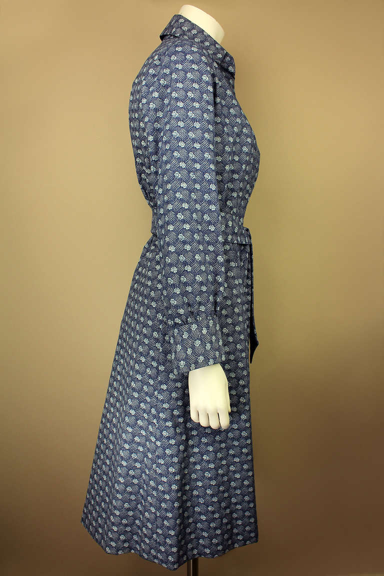 SALE Originally $250
Mr. John was best known for his millinery but he also had a salon in New York City where he sold women's clothing and furs. This lovely, trench-style coat is from that era. It has a distinctive blue floral pattern on the